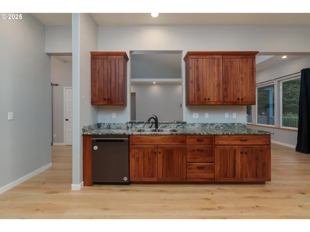a kitchen with granite countertop a sink cabinets and a granite counter top