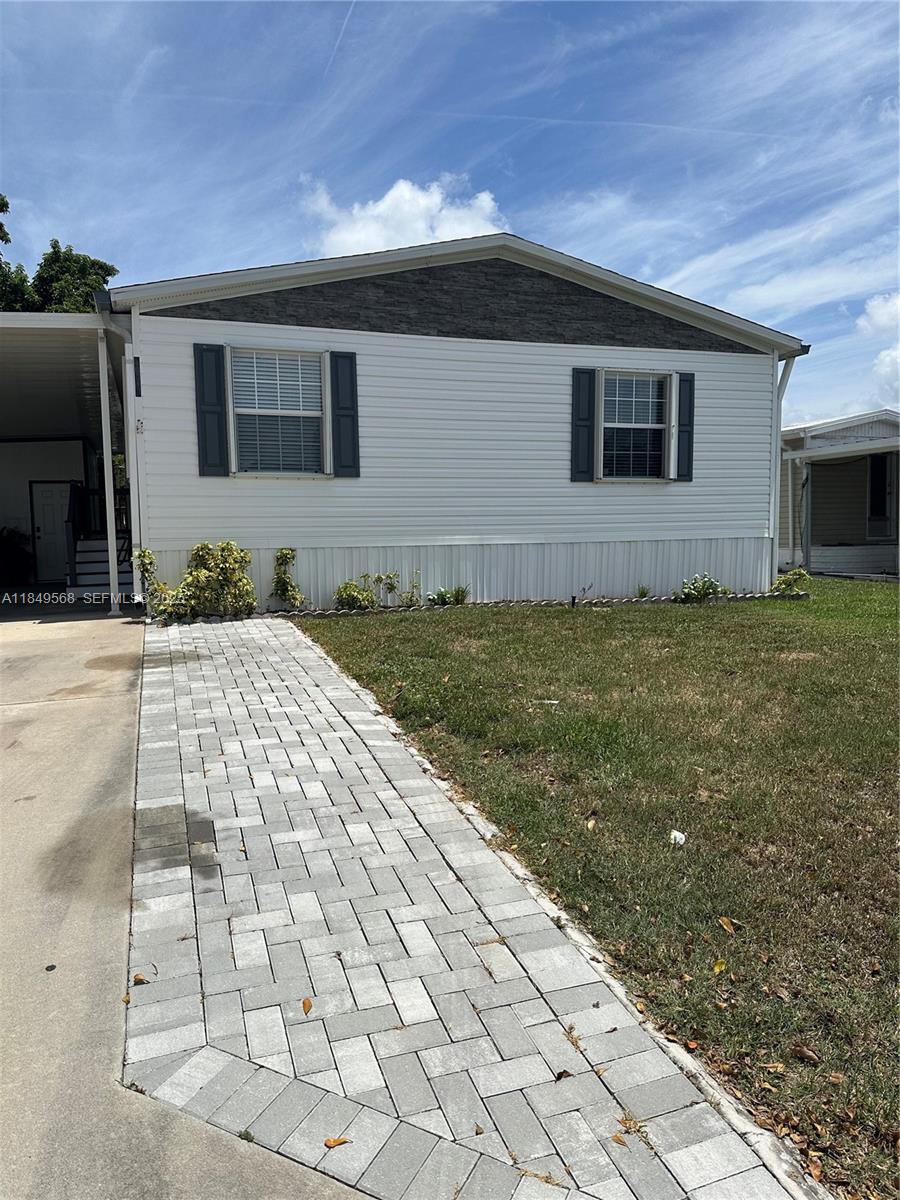 1570 Southwest 64th Way Boca Raton, FL 33428 - Photo 1 of 24 a backyard of a house