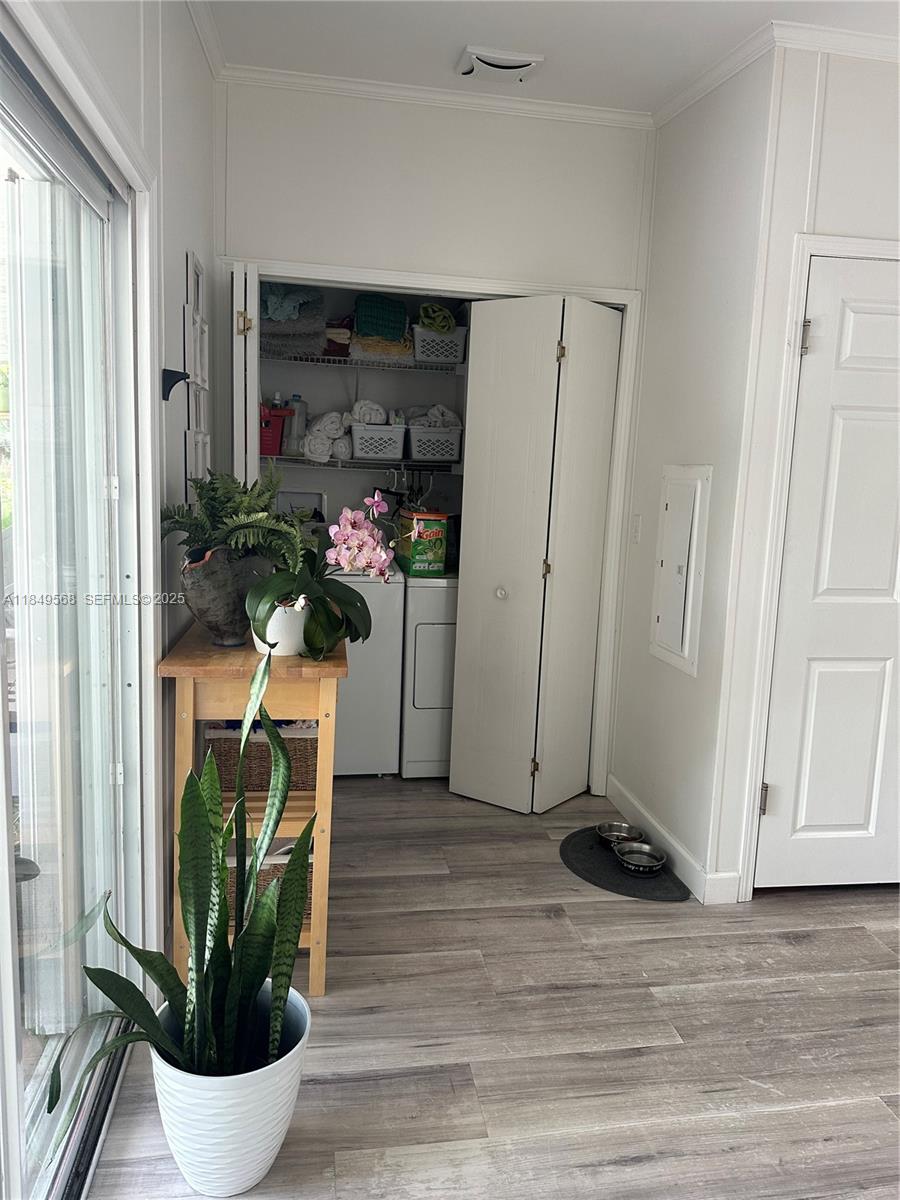 1570 Southwest 64th Way Boca Raton, FL 33428 - Photo 11 of 24 a view of a hallway with wooden floor and a potted plant