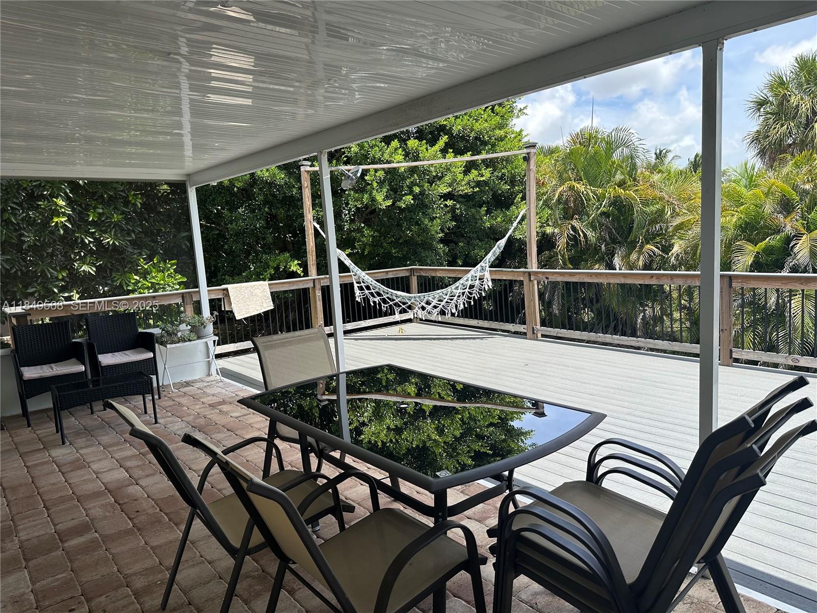 1570 Southwest 64th Way Boca Raton, FL 33428 - Photo 18 of 24 a view of a patio with lawn chairs next to a yard