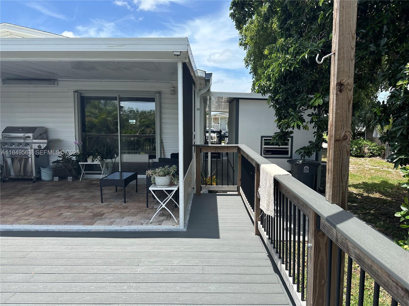 1570 Southwest 64th Way Boca Raton, FL 33428 - Photo 21 of 24 a view of a deck with wooden floor and outdoor seating