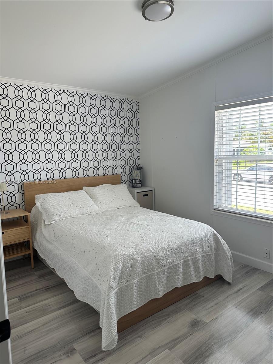 1570 Southwest 64th Way Boca Raton, FL 33428 - Photo 24 of 24 a bedroom with a bed and a window