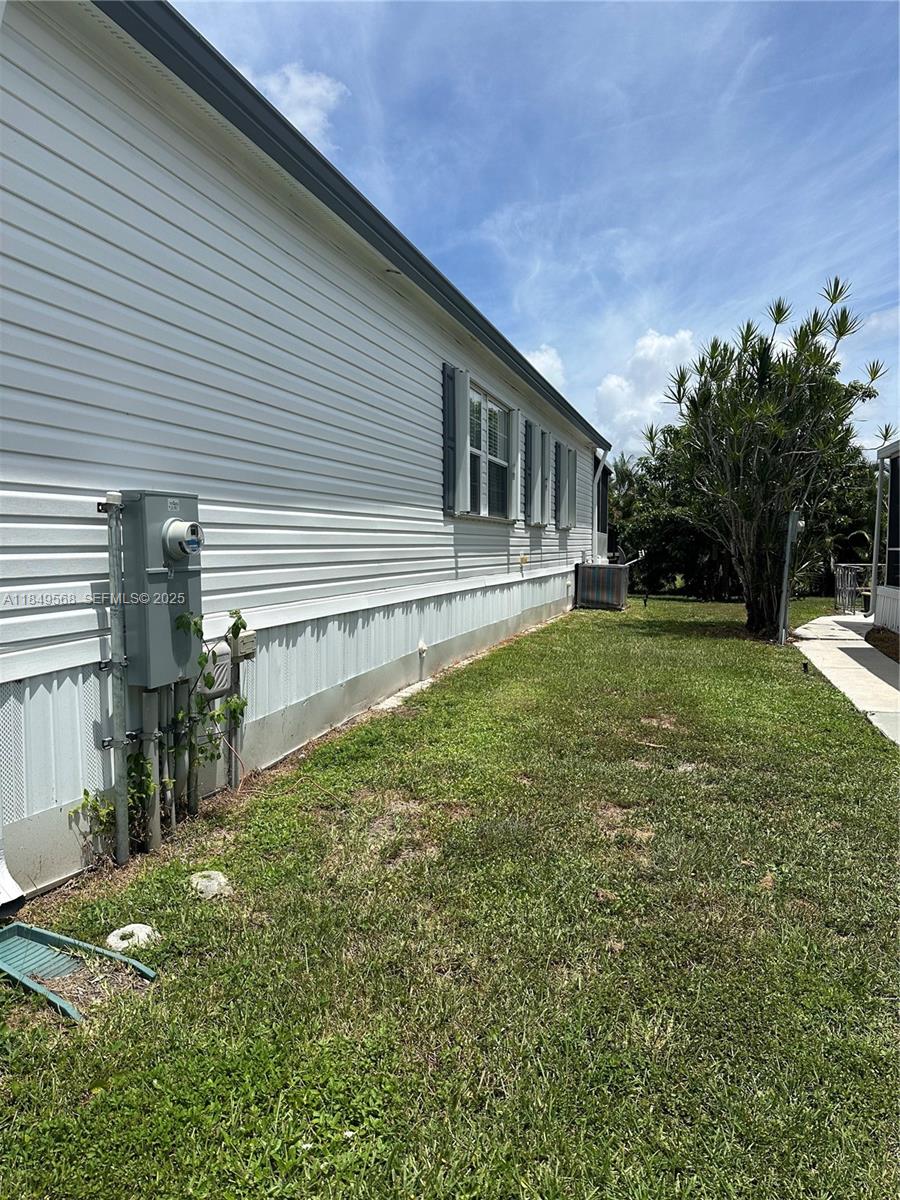 1570 Southwest 64th Way Boca Raton, FL 33428 - Photo 4 of 24 a view of a house with a yard