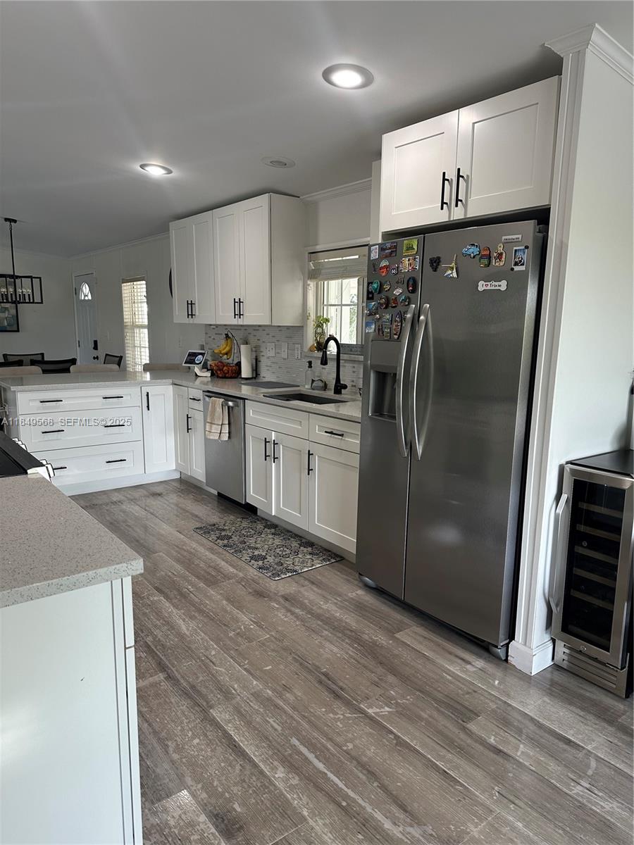 1570 Southwest 64th Way Boca Raton, FL 33428 - Photo 9 of 24 a kitchen with stainless steel appliances granite countertop a refrigerator a stove and a sink