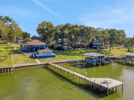 an aerial view of a house with a yard basket ball court and outdoor seating