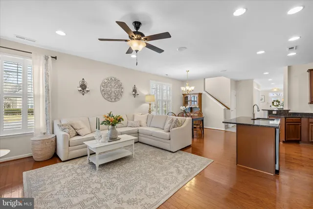 a spacious bedroom with a large bed and a chandelier