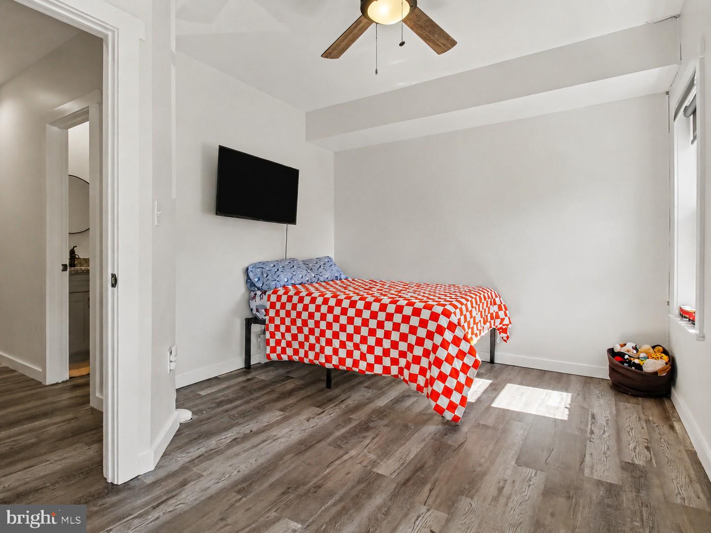 3915 Roland Avenue Baltimore, MD 21211 - Photo 12 of 26 a bedroom with a bed and a chandelier