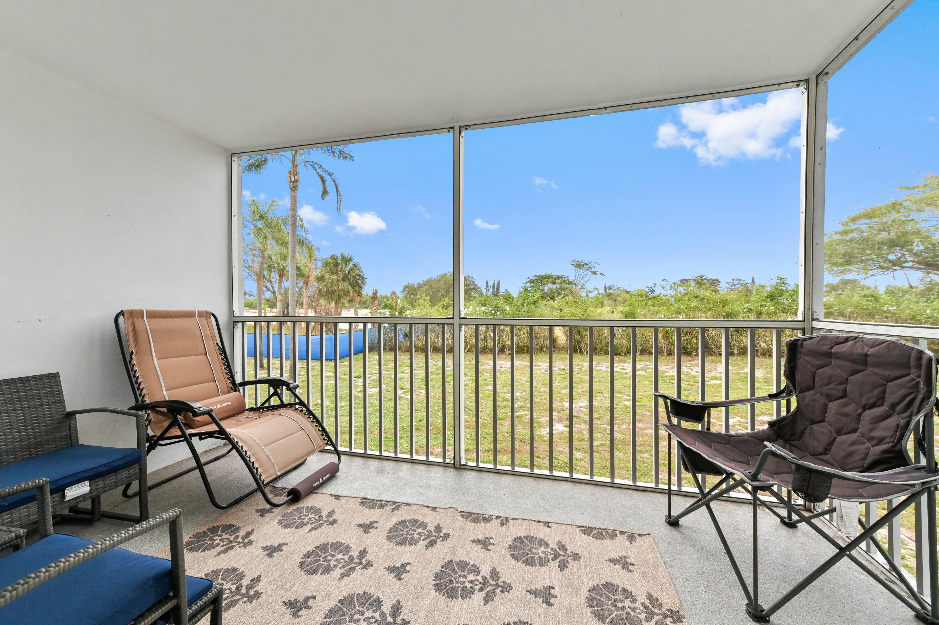 a living room with furniture and a floor to ceiling window