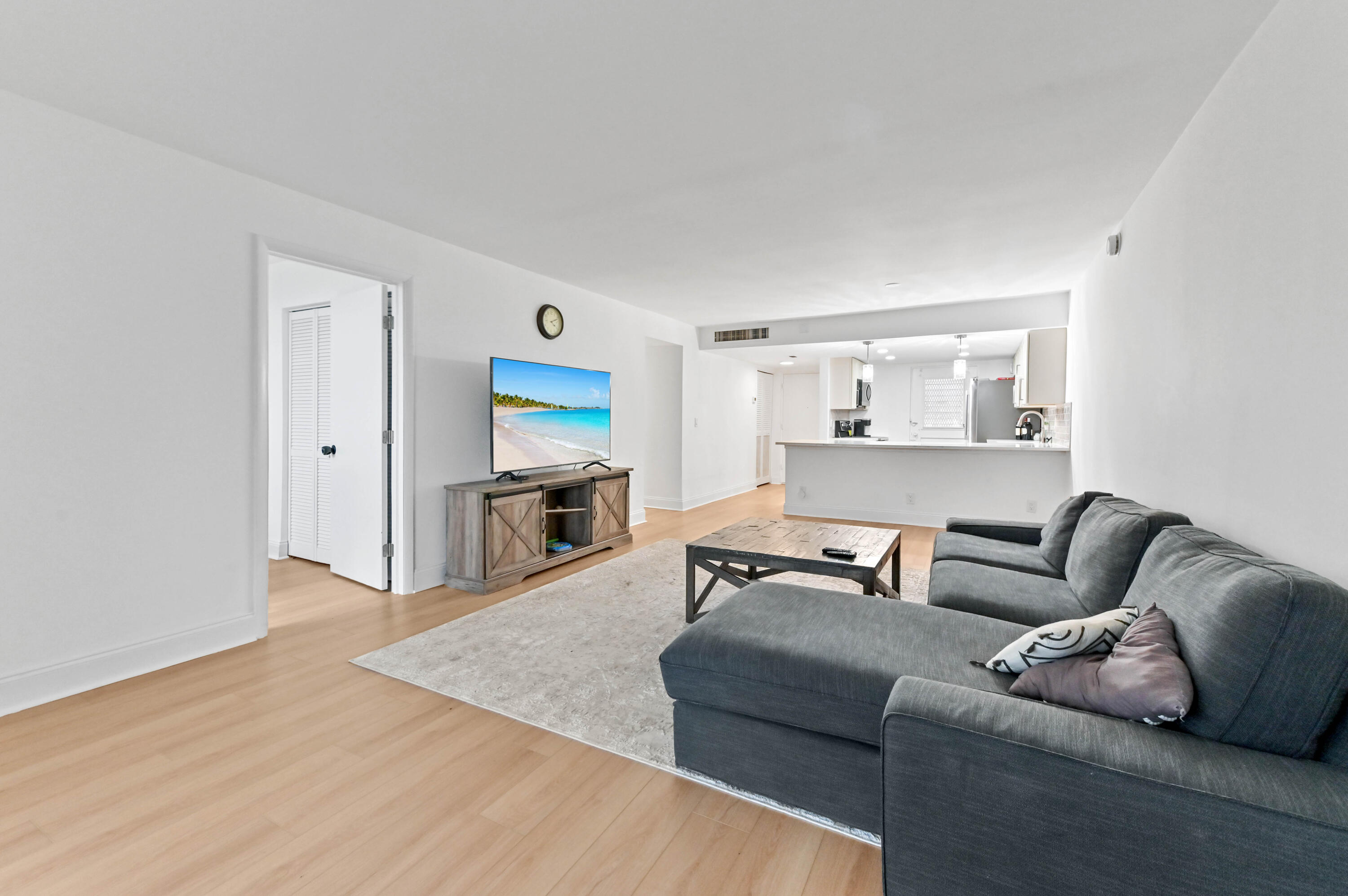 5700 Northwest 2nd Avenue, Unit 211 Boca Raton, FL 33487 - Photo 11 of 29 a living room with furniture and a wooden floor