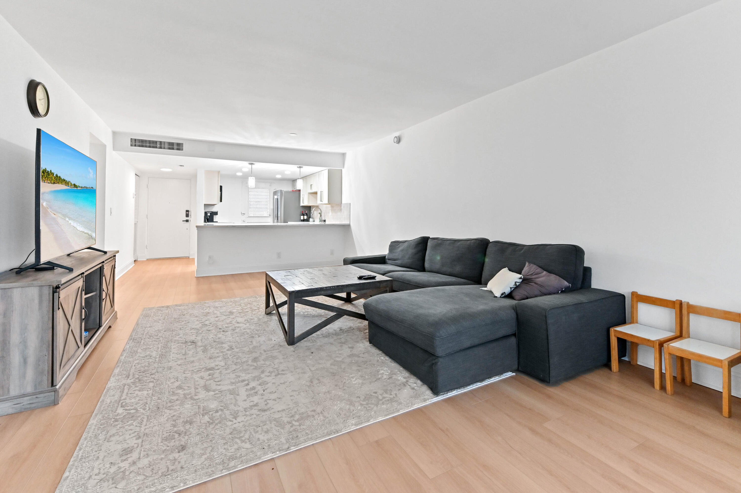 5700 Northwest 2nd Avenue, Unit 211 Boca Raton, FL 33487 - Photo 12 of 29 a living room with furniture and a flat screen tv