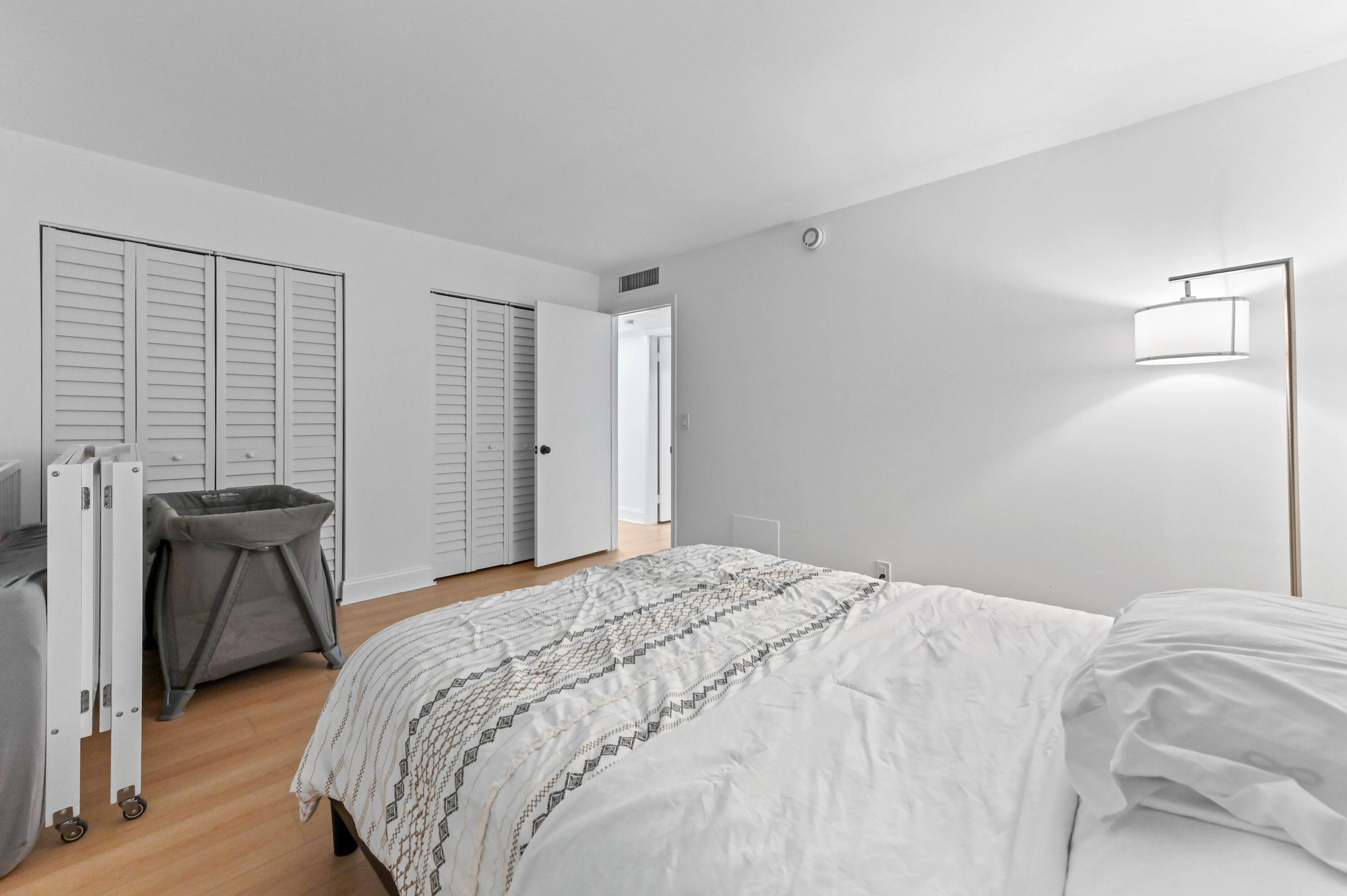 5700 Northwest 2nd Avenue, Unit 211 Boca Raton, FL 33487 - Photo 15 of 29 a bedroom with a bed and a table in it