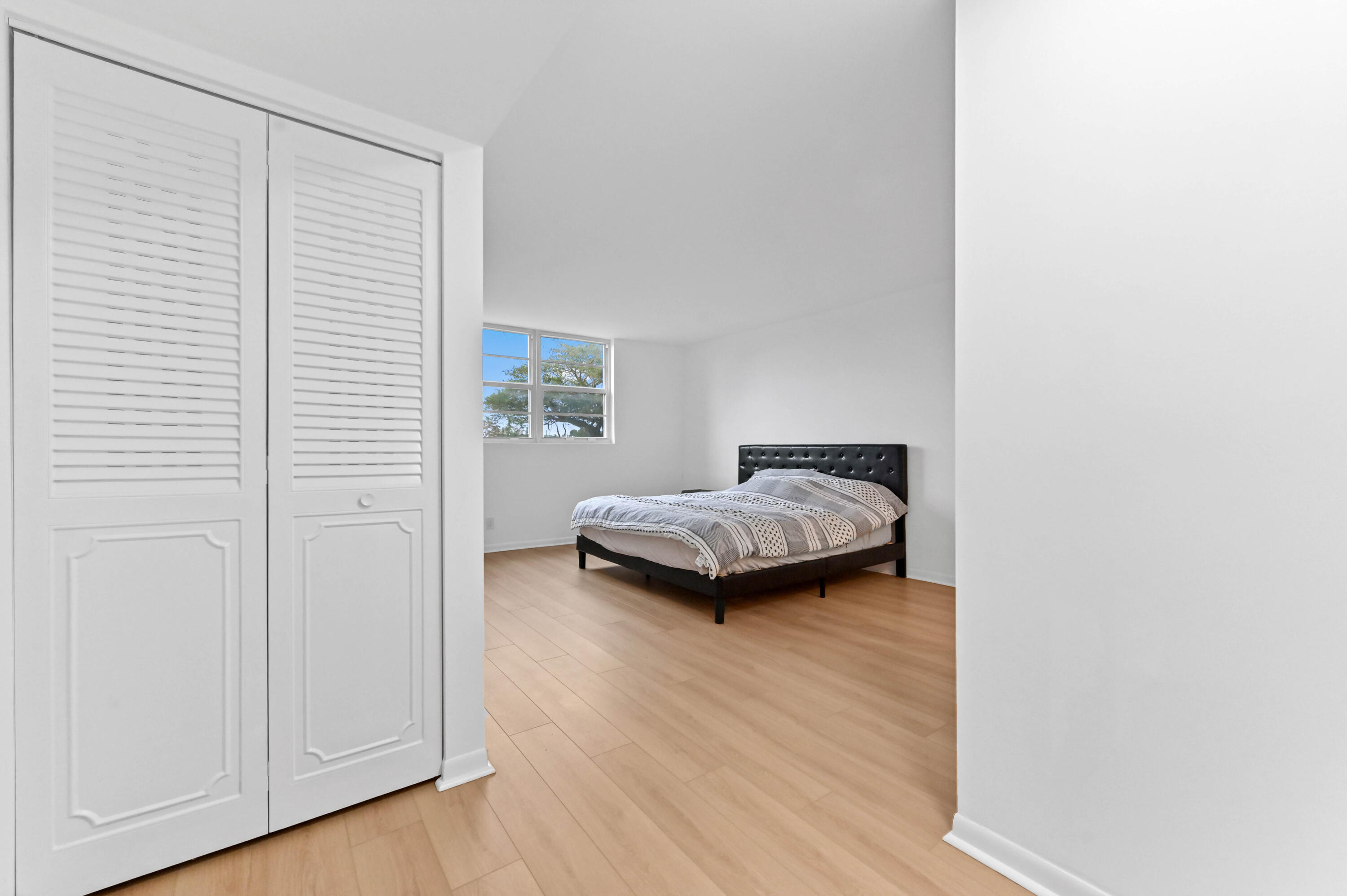 5700 Northwest 2nd Avenue, Unit 211 Boca Raton, FL 33487 - Photo 16 of 29 a bedroom with a bed and a window