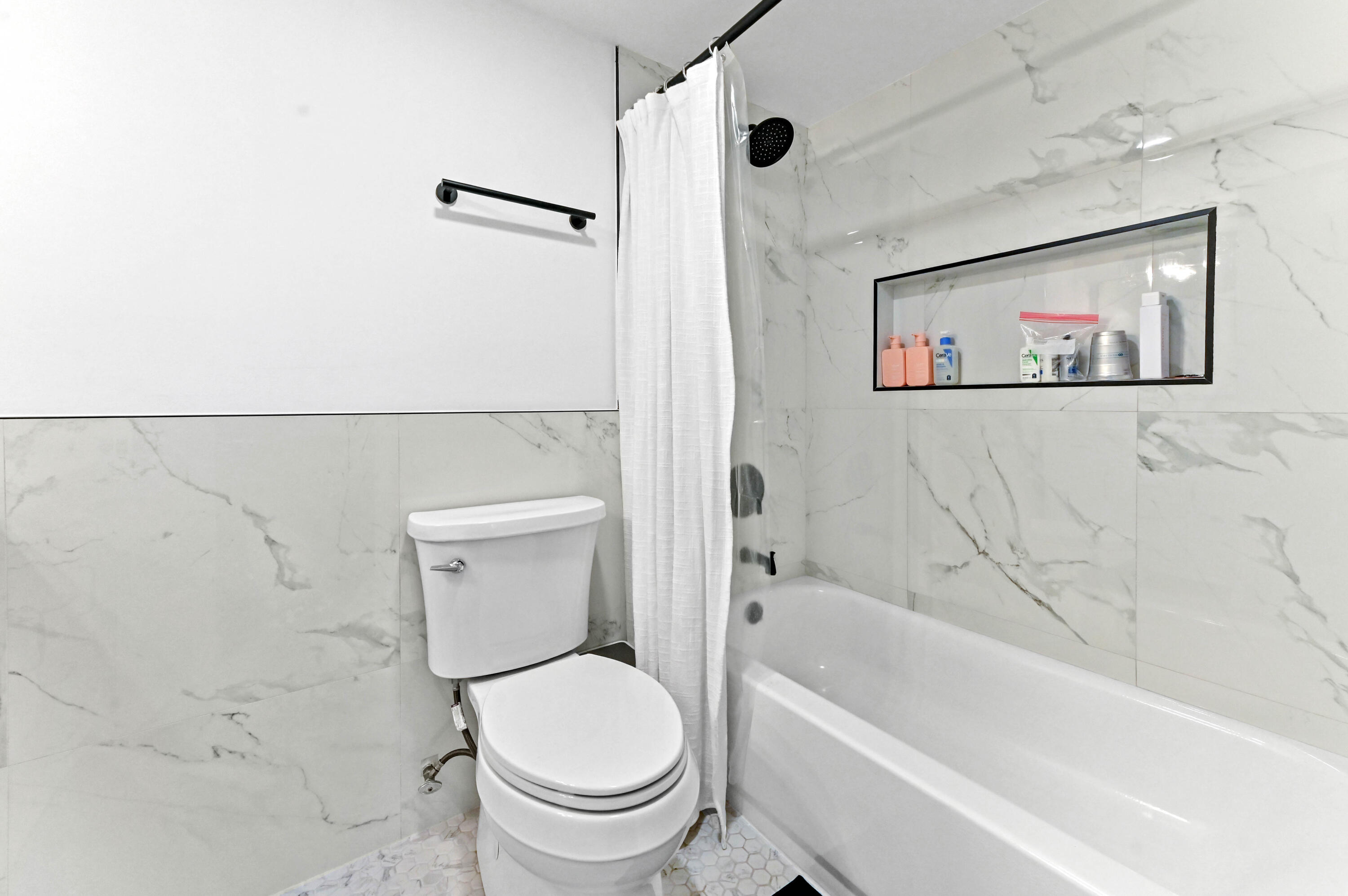 5700 Northwest 2nd Avenue, Unit 211 Boca Raton, FL 33487 - Photo 20 of 29 a bathroom with a toilet and a tub