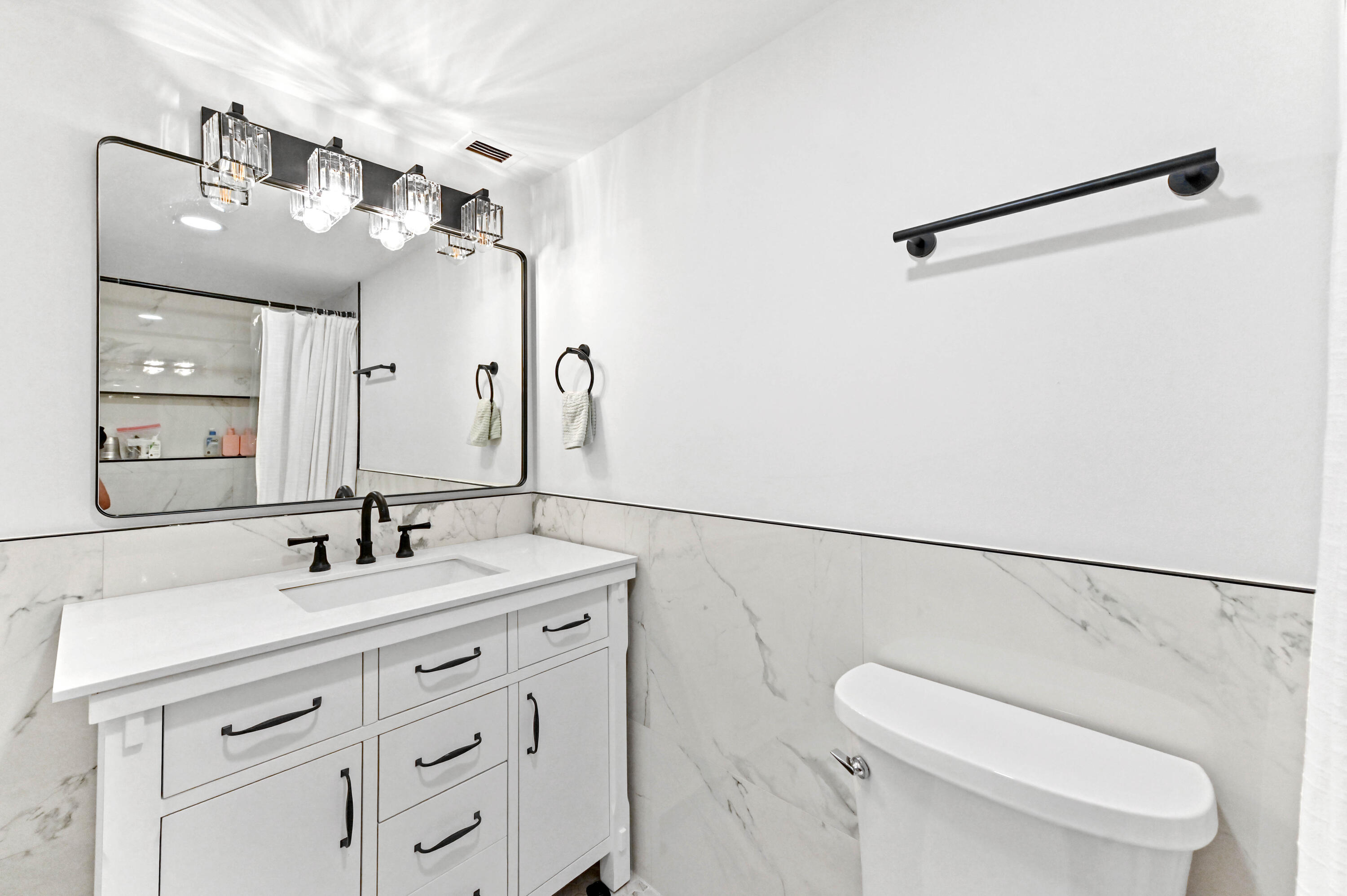 5700 Northwest 2nd Avenue, Unit 211 Boca Raton, FL 33487 - Photo 21 of 29 a bathroom with a double vanity sink mirror and toilet