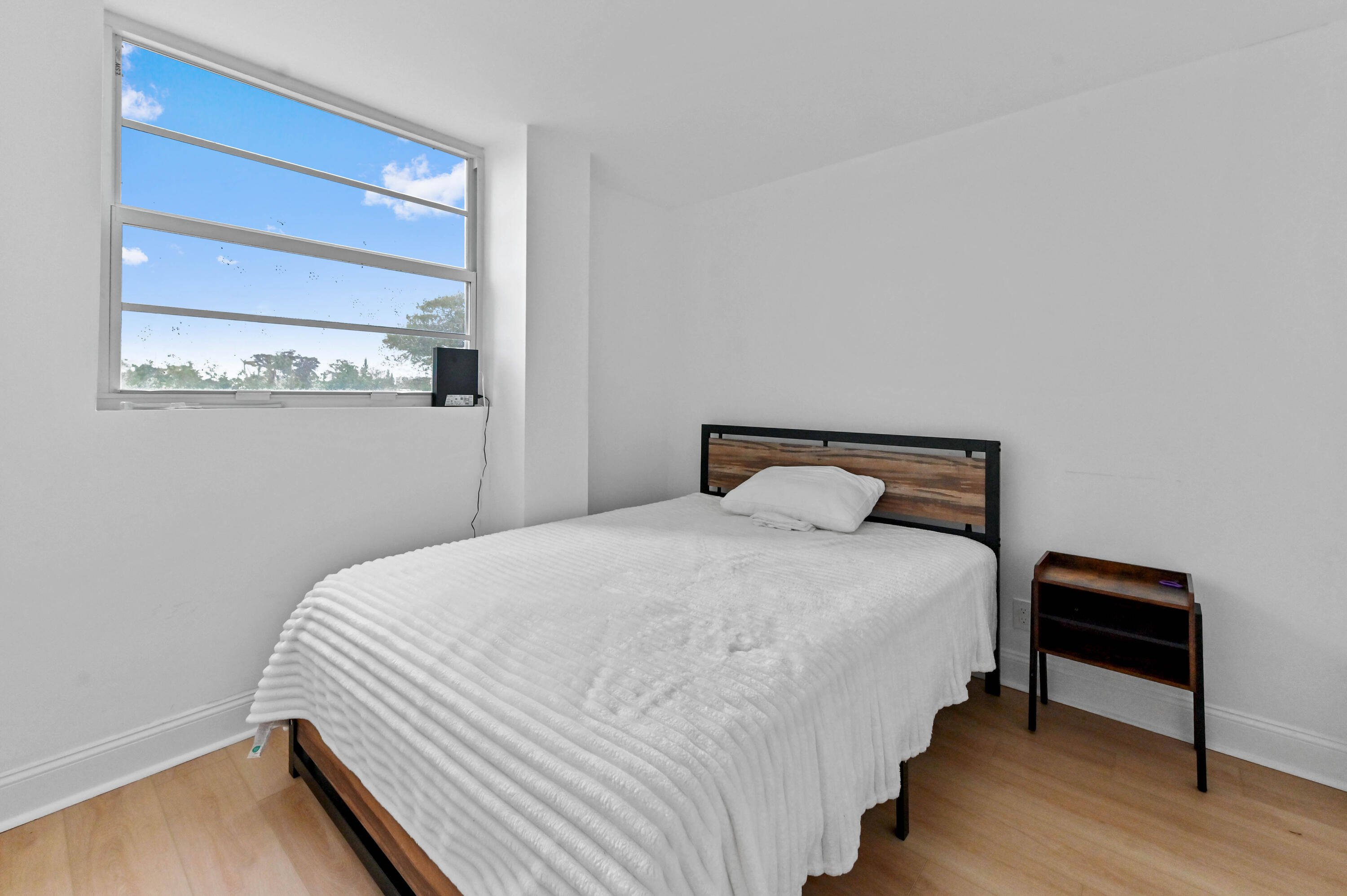 5700 Northwest 2nd Avenue, Unit 211 Boca Raton, FL 33487 - Photo 23 of 29 a bedroom with bed and a window