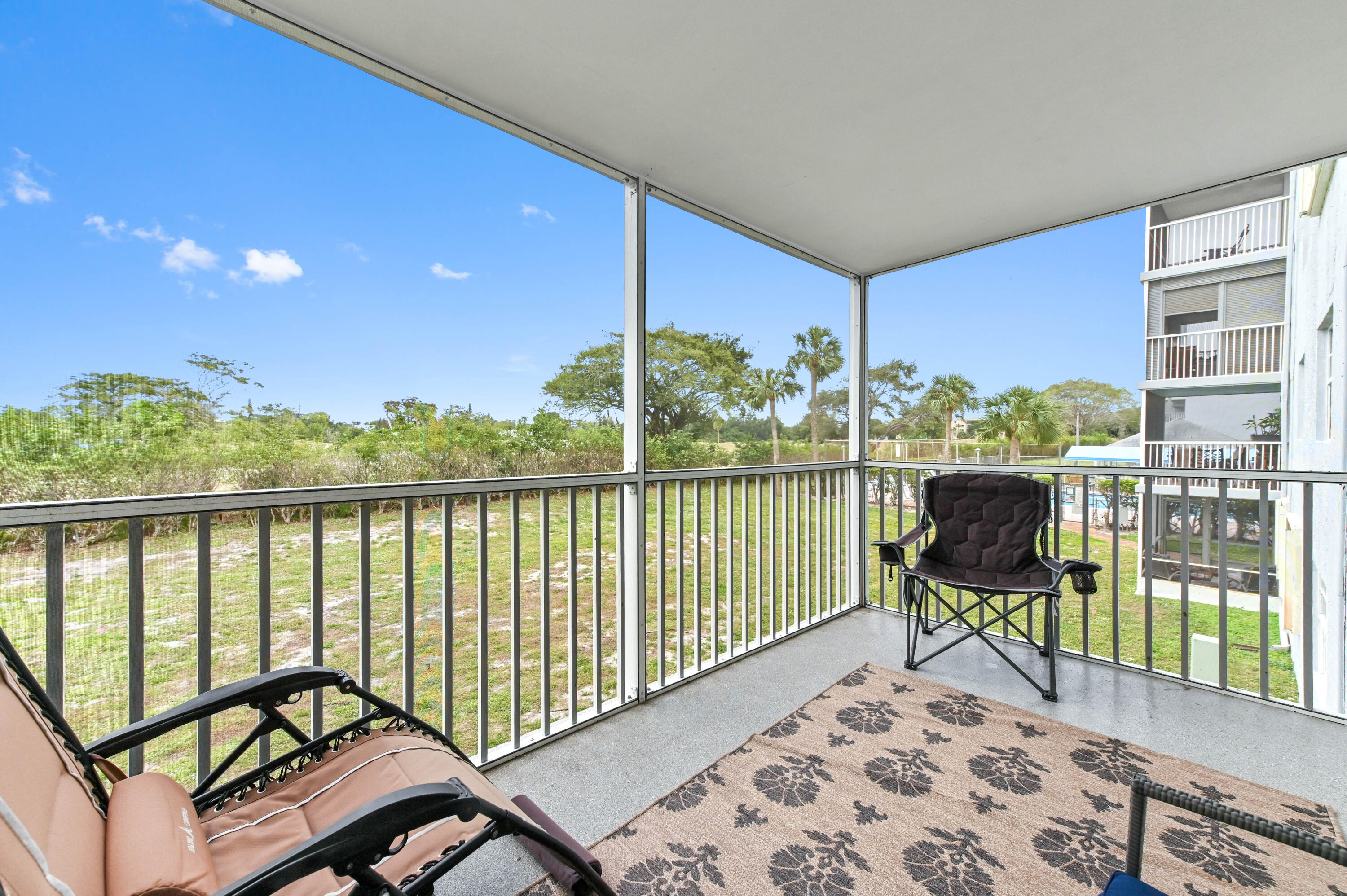 5700 Northwest 2nd Avenue, Unit 211 Boca Raton, FL 33487 - Photo 26 of 29 a view of a chairs and table in the balcony