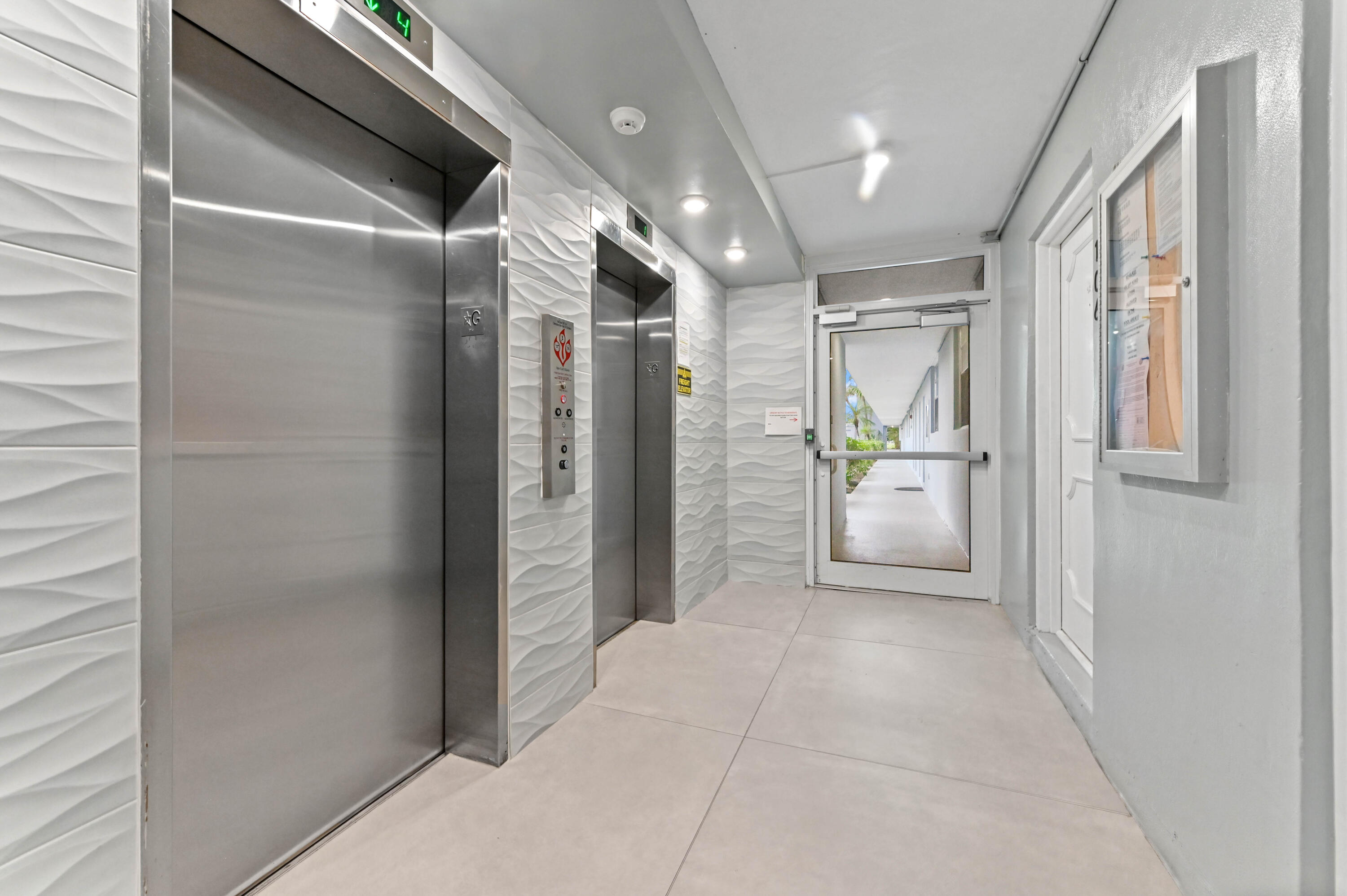 5700 Northwest 2nd Avenue, Unit 211 Boca Raton, FL 33487 - Photo 27 of 29 a view of a hallway with wooden shelves