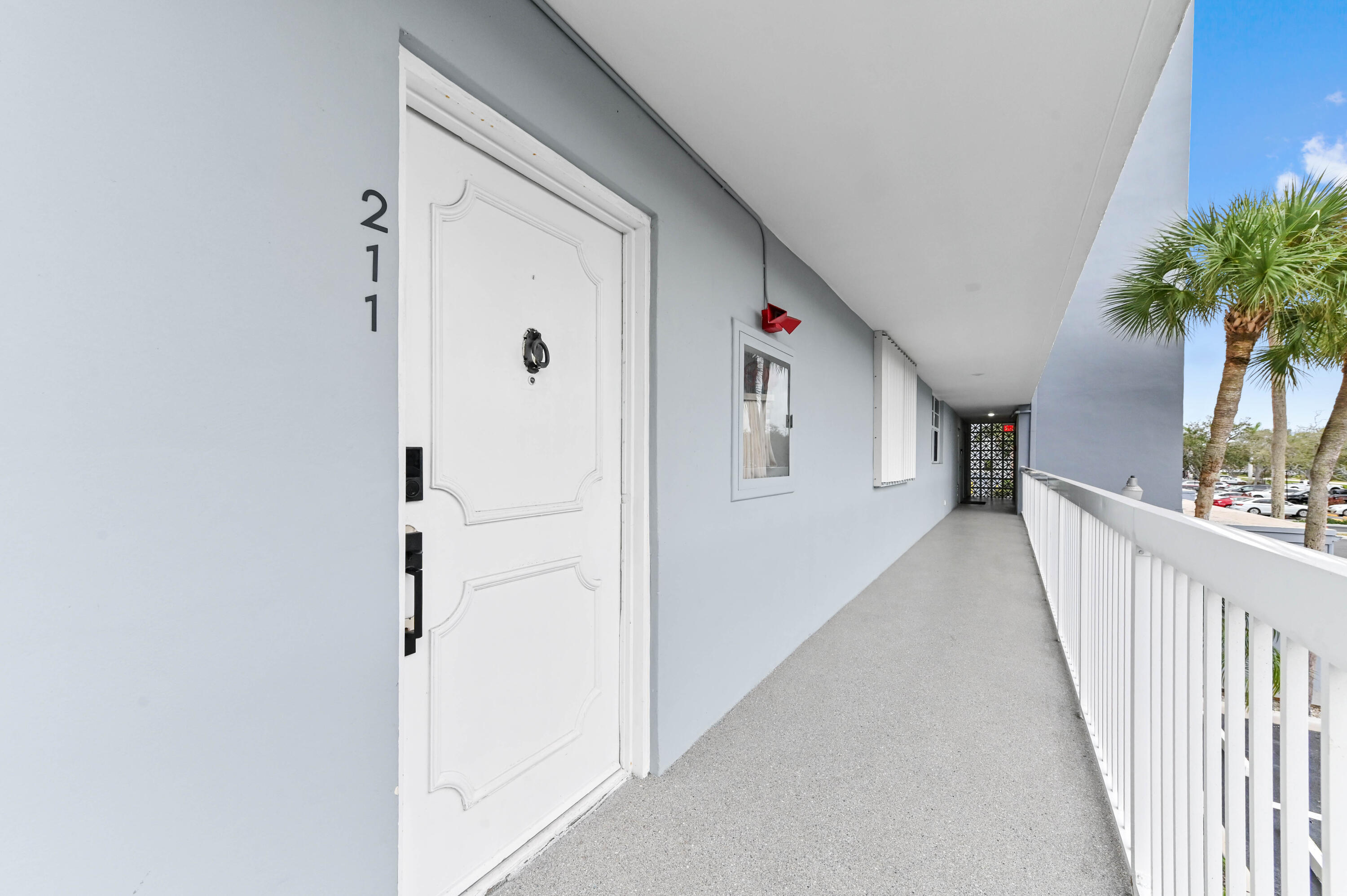 5700 Northwest 2nd Avenue, Unit 211 Boca Raton, FL 33487 - Photo 3 of 29 a view of a hallway with wooden floor and entryway