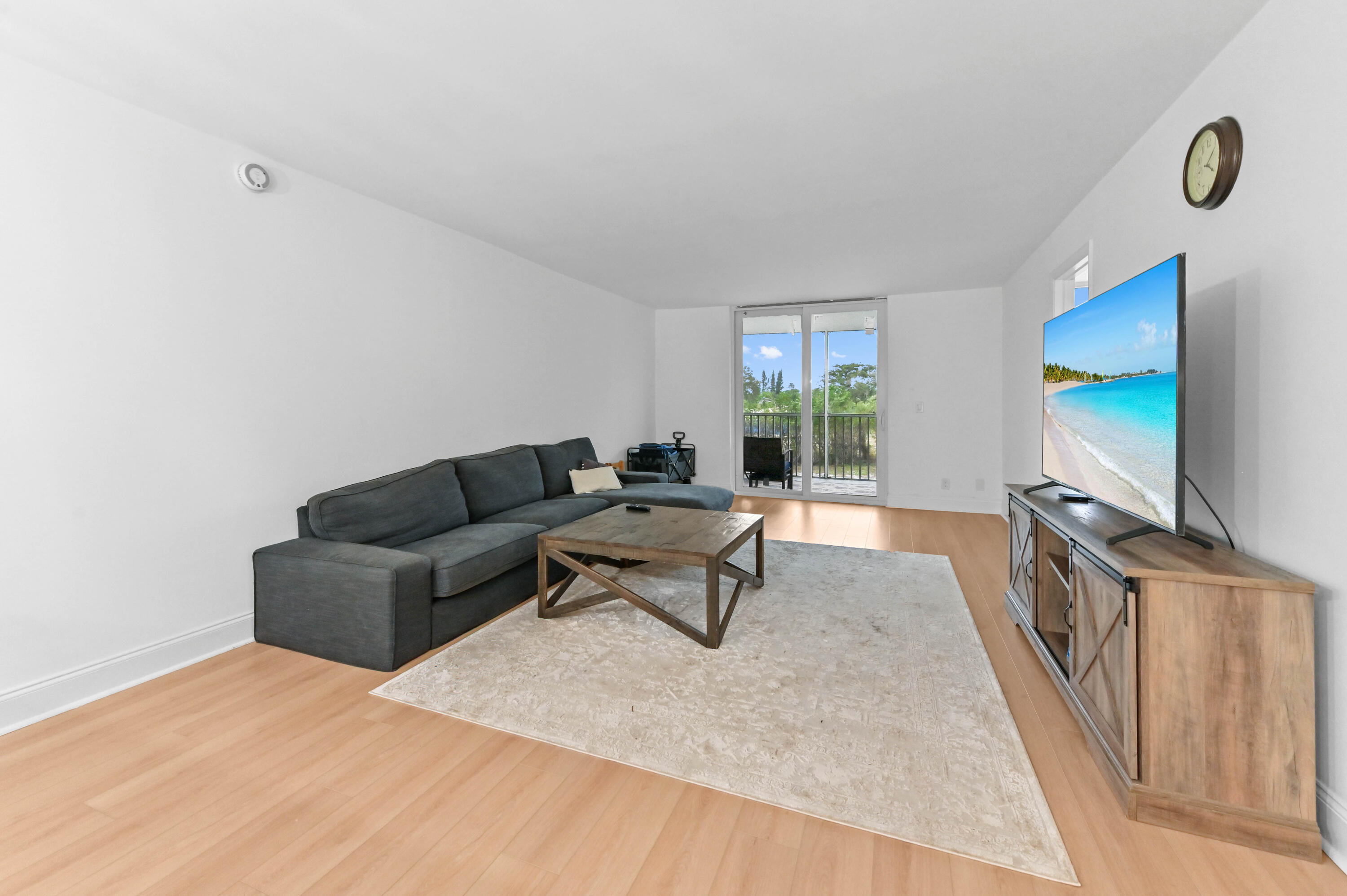 5700 Northwest 2nd Avenue, Unit 211 Boca Raton, FL 33487 - Photo 8 of 29 a living room with furniture and a flat screen tv