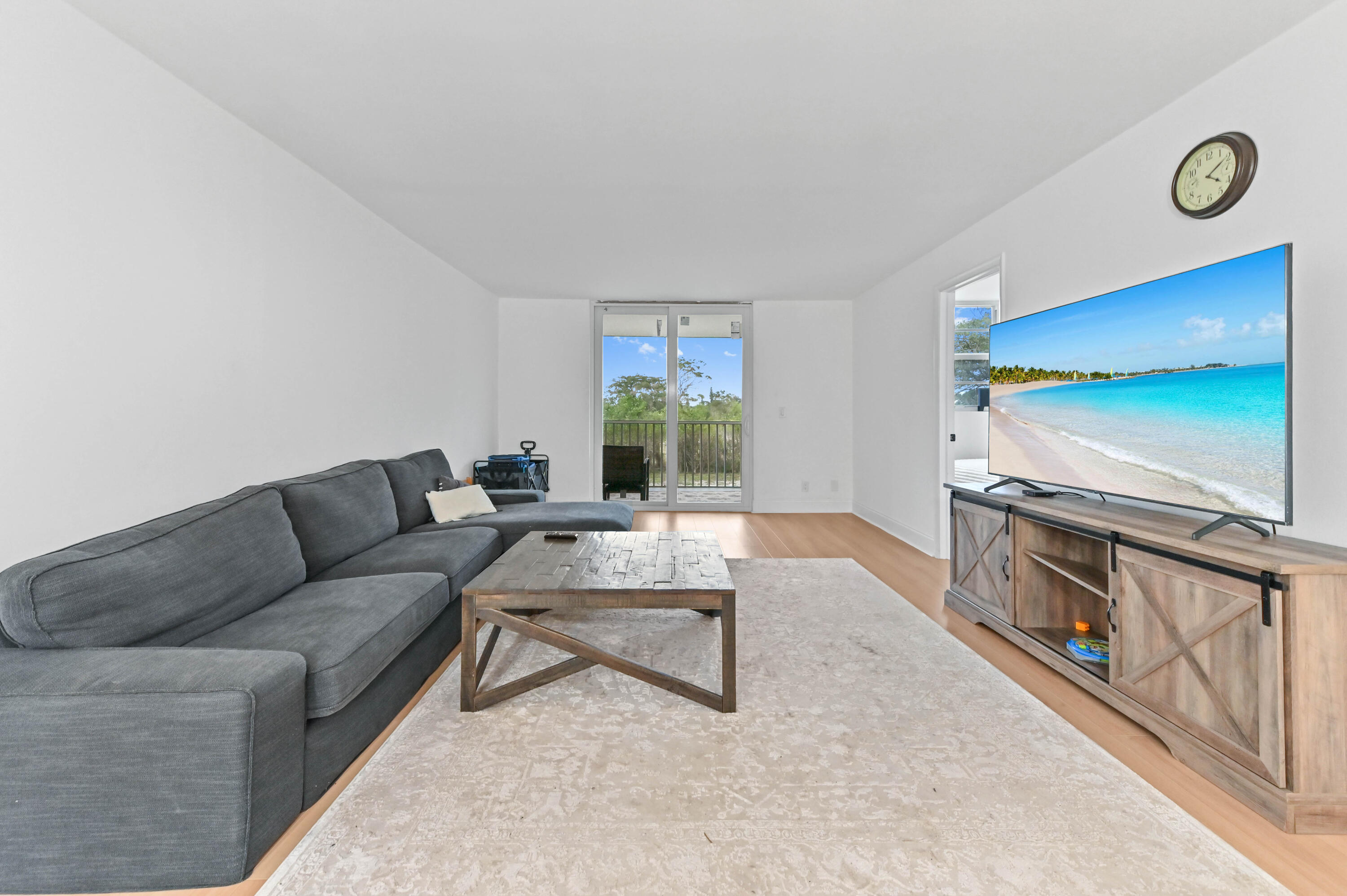 5700 Northwest 2nd Avenue, Unit 211 Boca Raton, FL 33487 - Photo 10 of 29 a living room with furniture and a flat screen tv