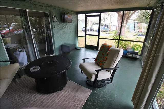 a living room with furniture and a floor to ceiling window