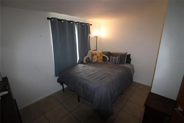 a bedroom with a bed and a mirror