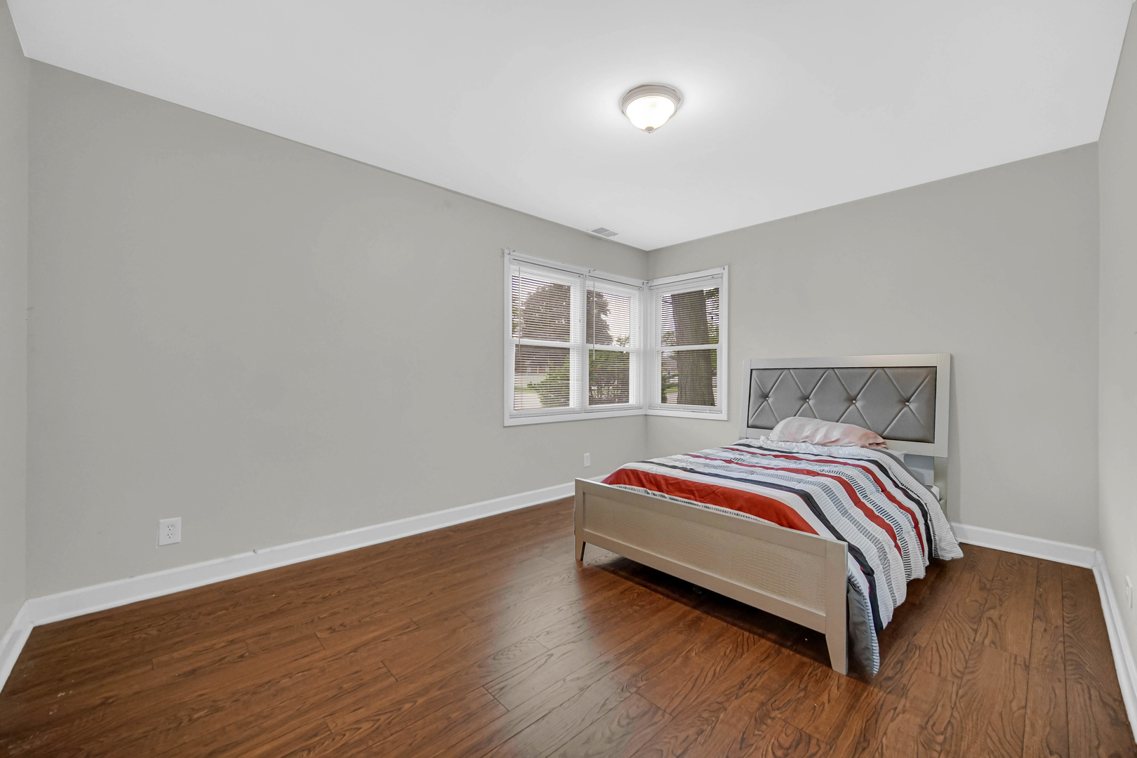 6330 107th Street Chicago Ridge, IL 60415 - Photo 18 of 27 a bedroom with a bed and wooden floor
