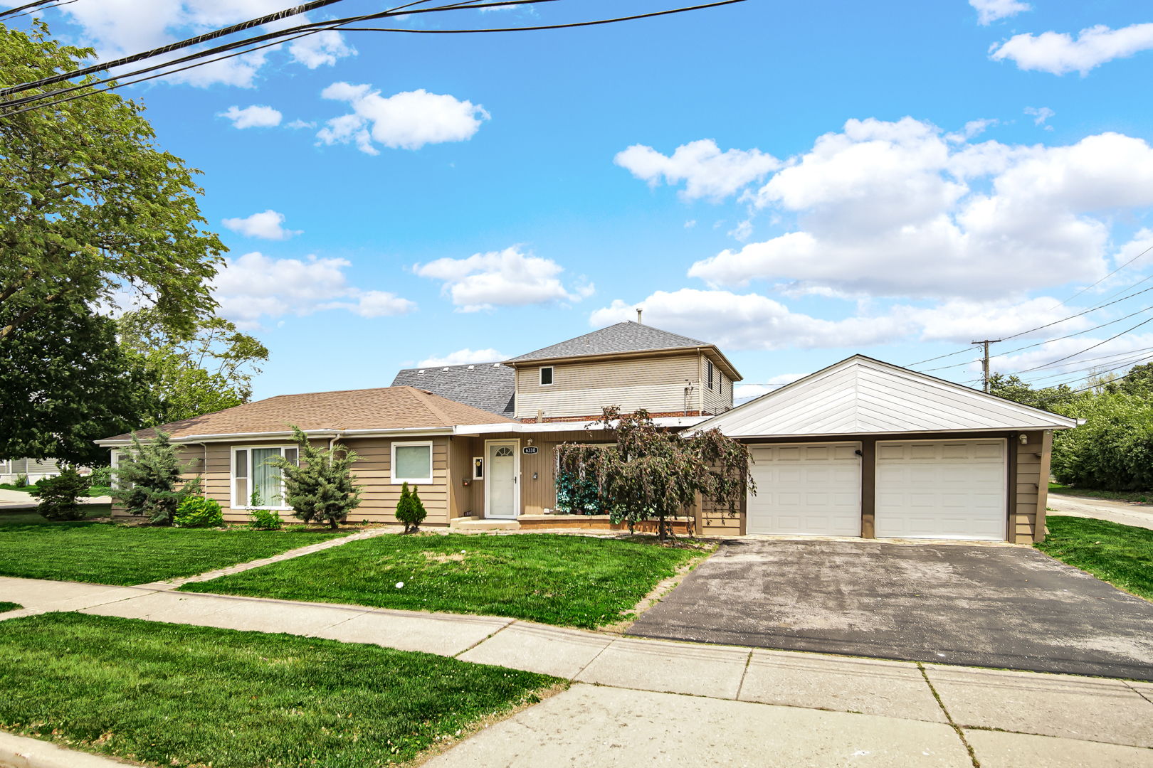 6330 107th Street Chicago Ridge, IL 60415 - Photo 3 of 27 a front view of a house with a garden and yard