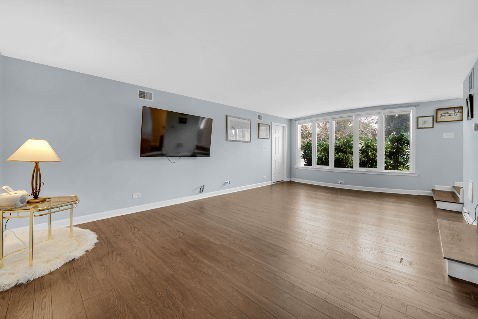 6330 107th Street Chicago Ridge, IL 60415 - Photo 7 of 27 a view of a livingroom with furniture window and a wooden floor