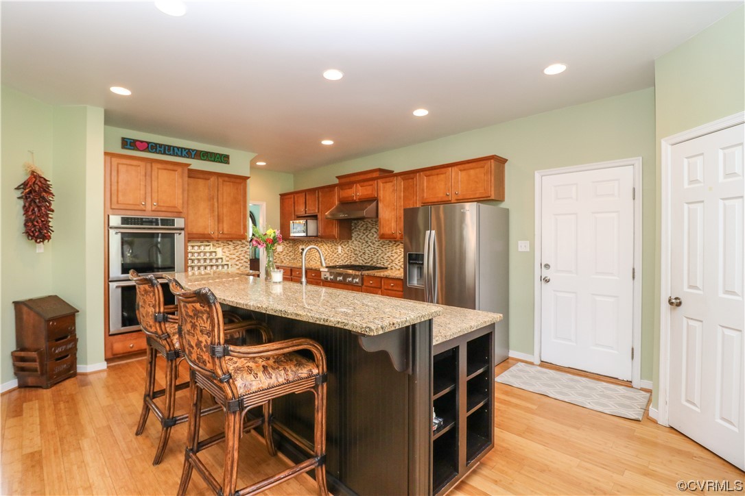 4628 Allenbend Road Glen Allen, VA 23060 - Photo 11 of 50 a kitchen with stainless steel appliances granite countertop a table chairs and a refrigerator
