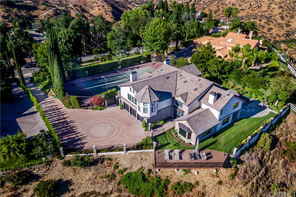 10 North Corral Road Bell Canyon, CA 91307 - Photo 1 of 1 an aerial view of a house with a garden and trees