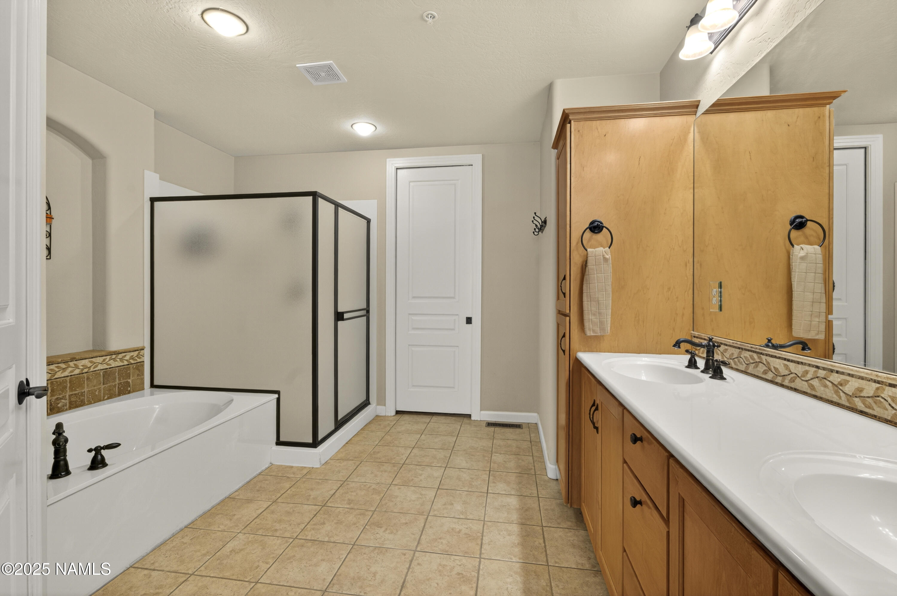 4900 West Quick Draw Flagstaff, AZ 86005 - Photo 9 of 36 a bathroom with a tub sink shower and mirror