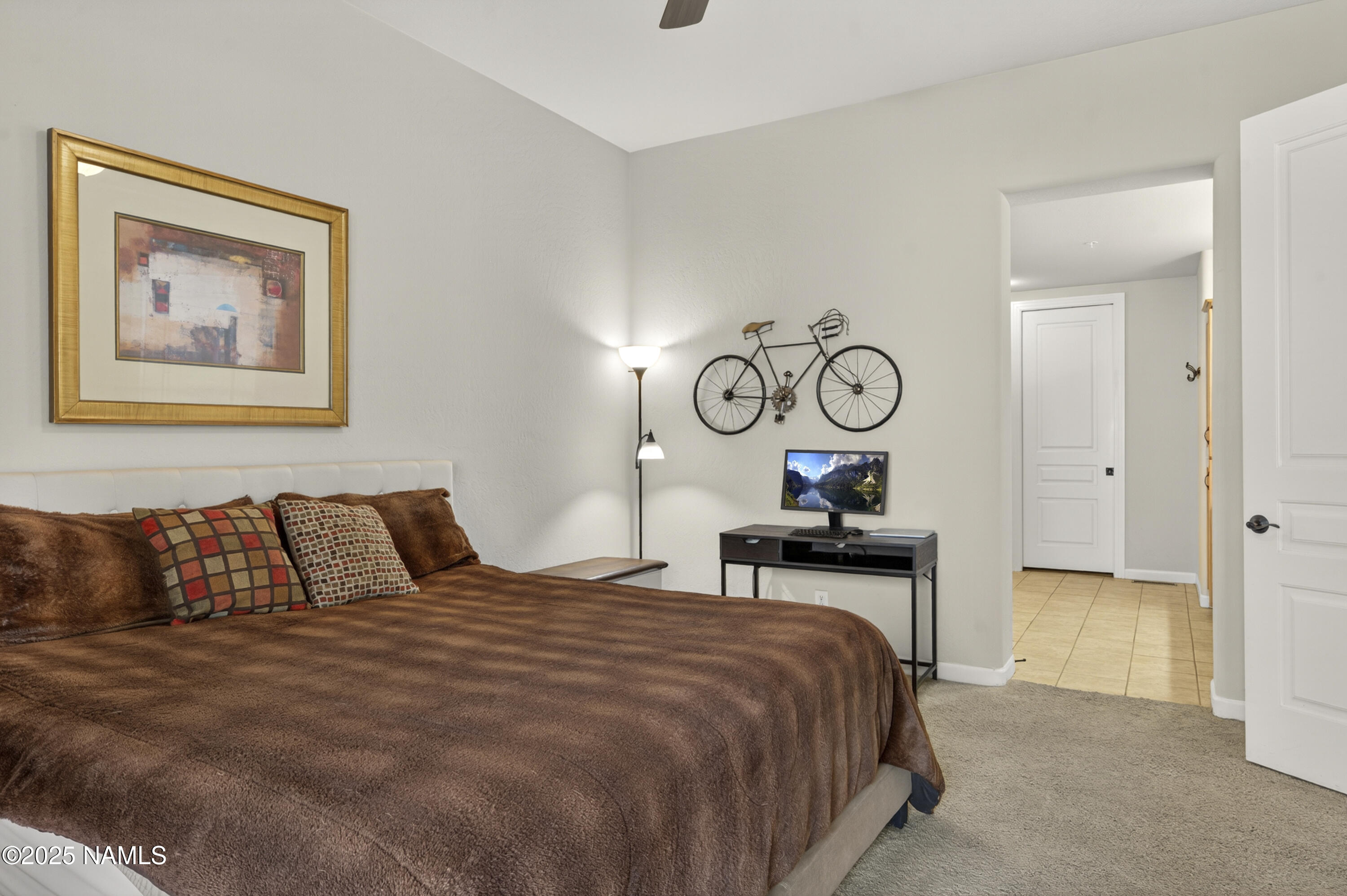 4900 West Quick Draw Flagstaff, AZ 86005 - Photo 10 of 36 a bedroom with a bed and painting on the wall