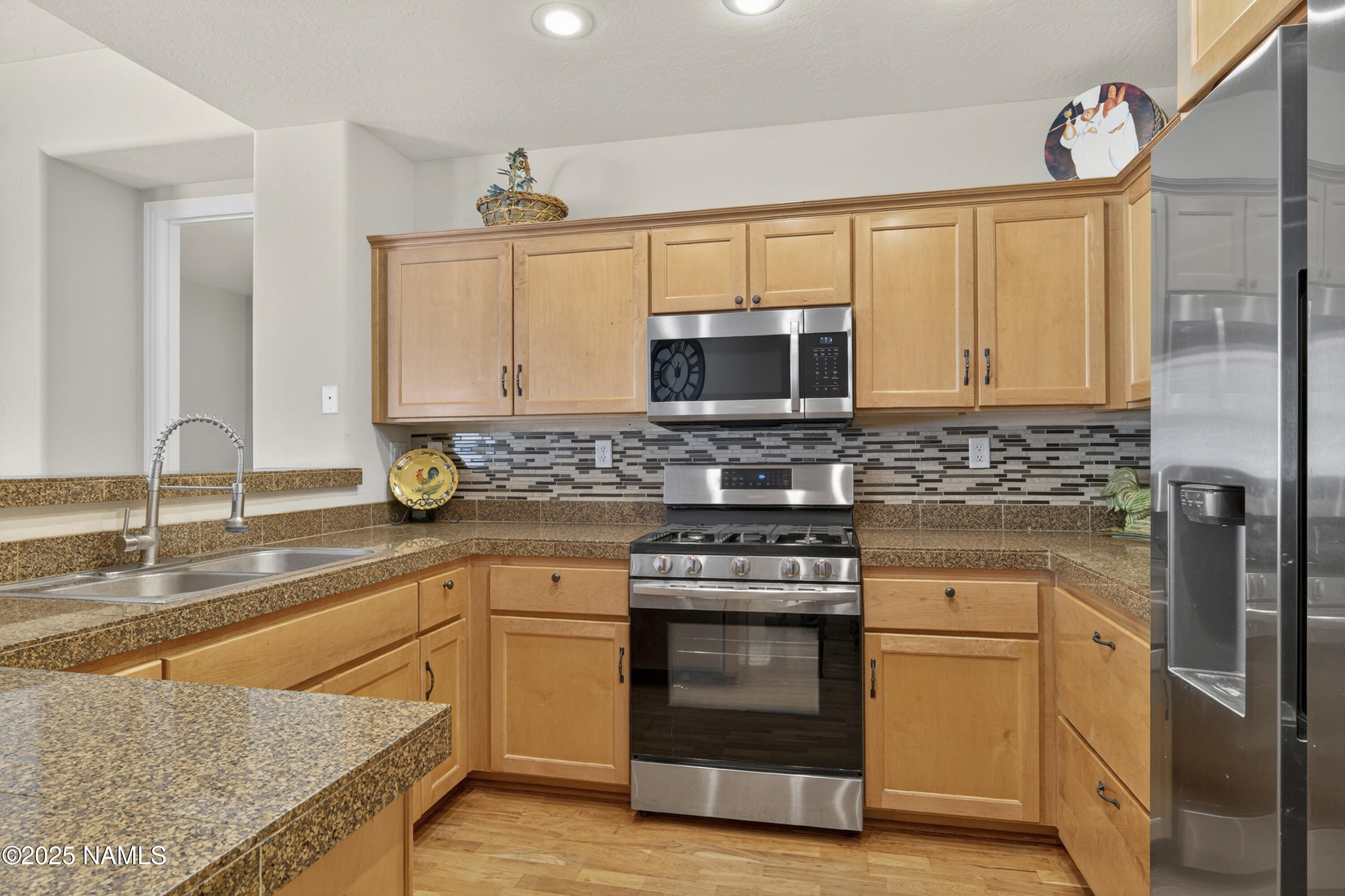 4900 West Quick Draw Flagstaff, AZ 86005 - Photo 11 of 36 a kitchen with stainless steel appliances granite countertop a stove a sink and a microwave
