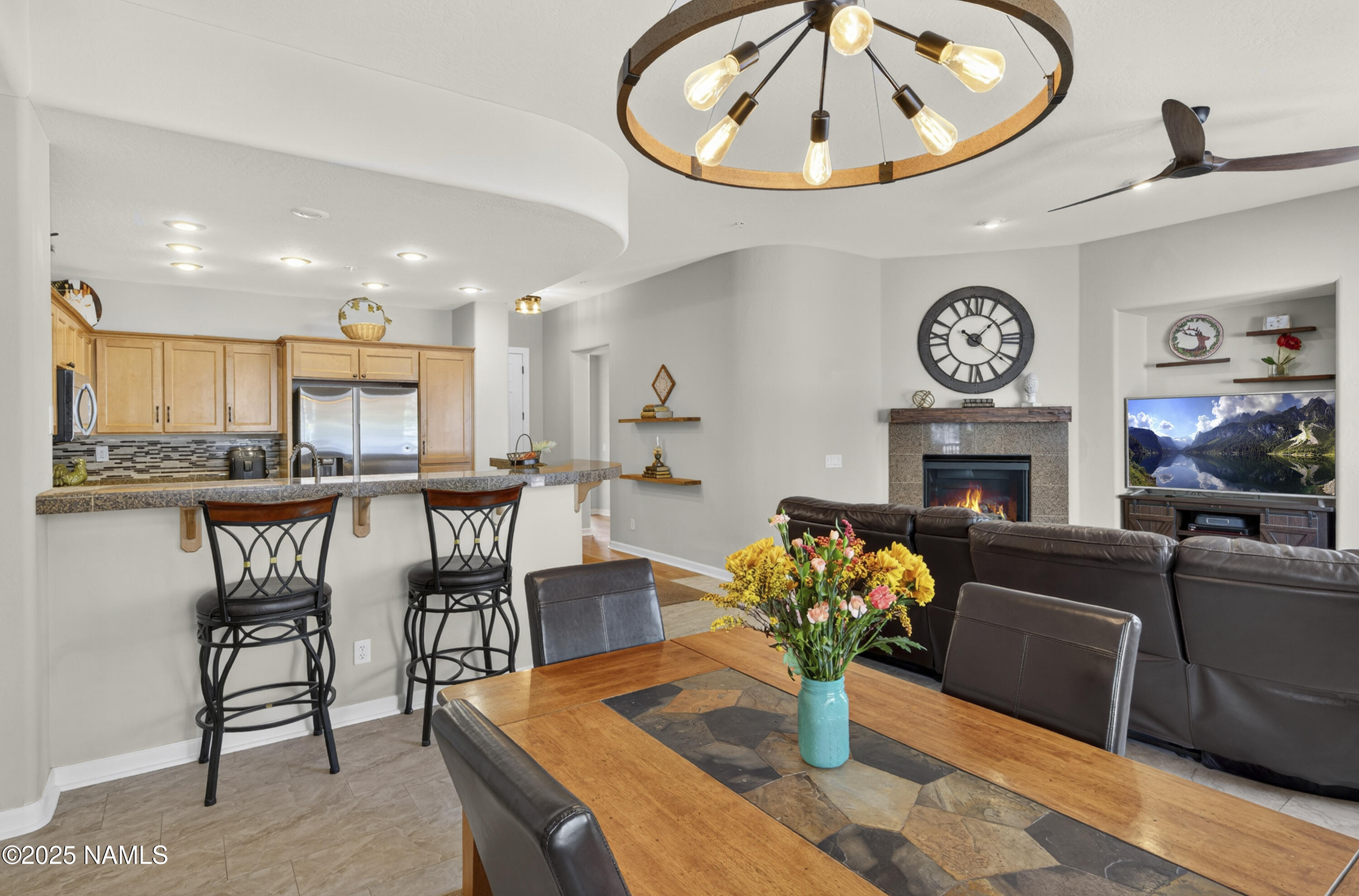 4900 West Quick Draw Flagstaff, AZ 86005 - Photo 13 of 36 a living room with furniture a fireplace and a clock
