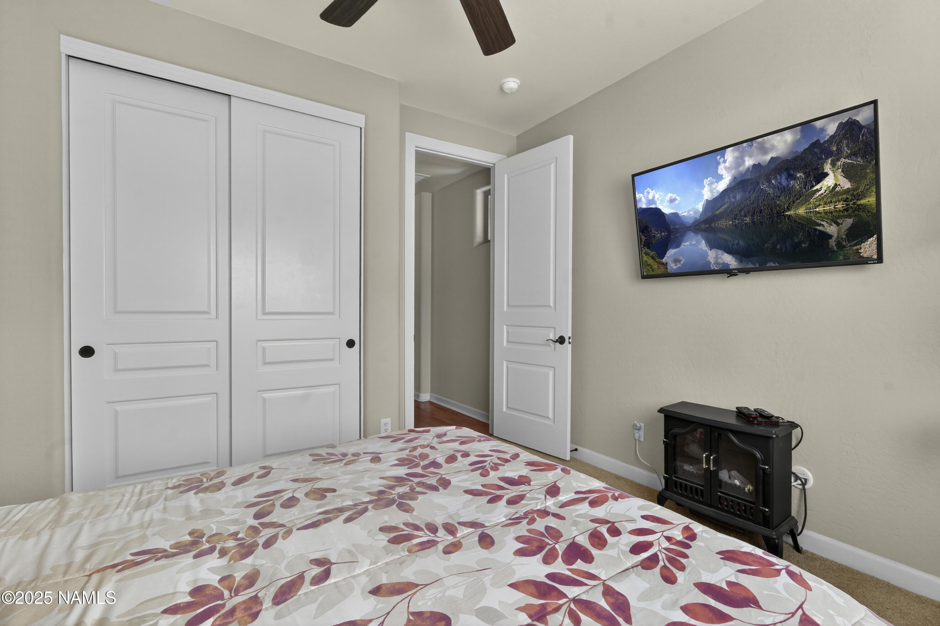 4900 West Quick Draw Flagstaff, AZ 86005 - Photo 16 of 36 a bedroom with a bed and a lamp on dresser