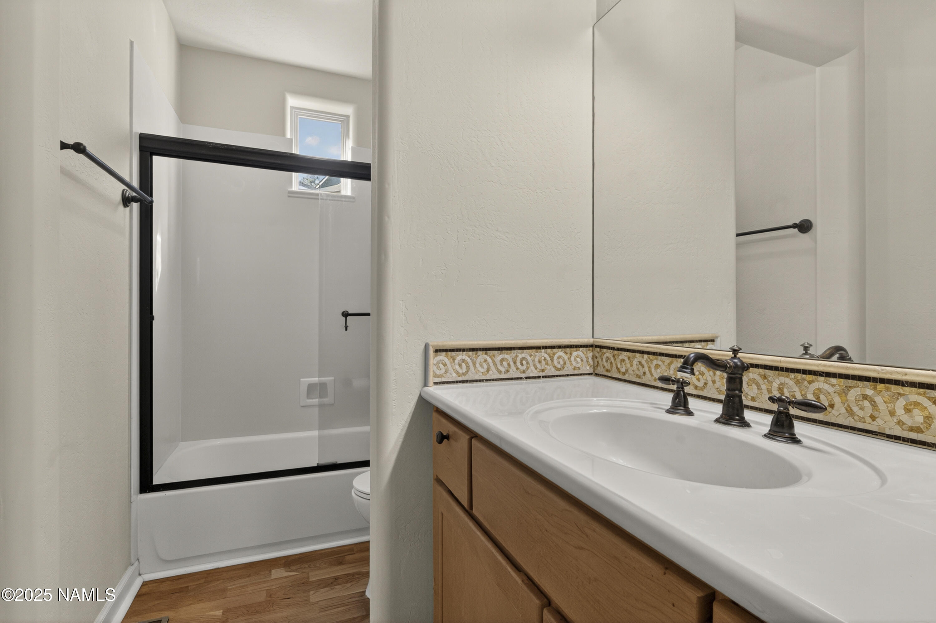 4900 West Quick Draw Flagstaff, AZ 86005 - Photo 17 of 36 a bathroom with a sink and mirror
