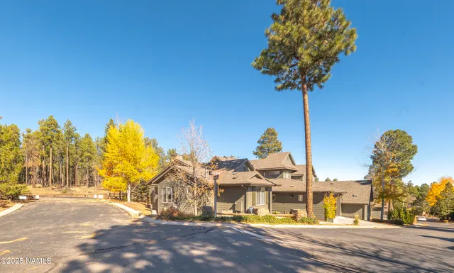 an aerial view of residential house with outdoor space and swimming pool