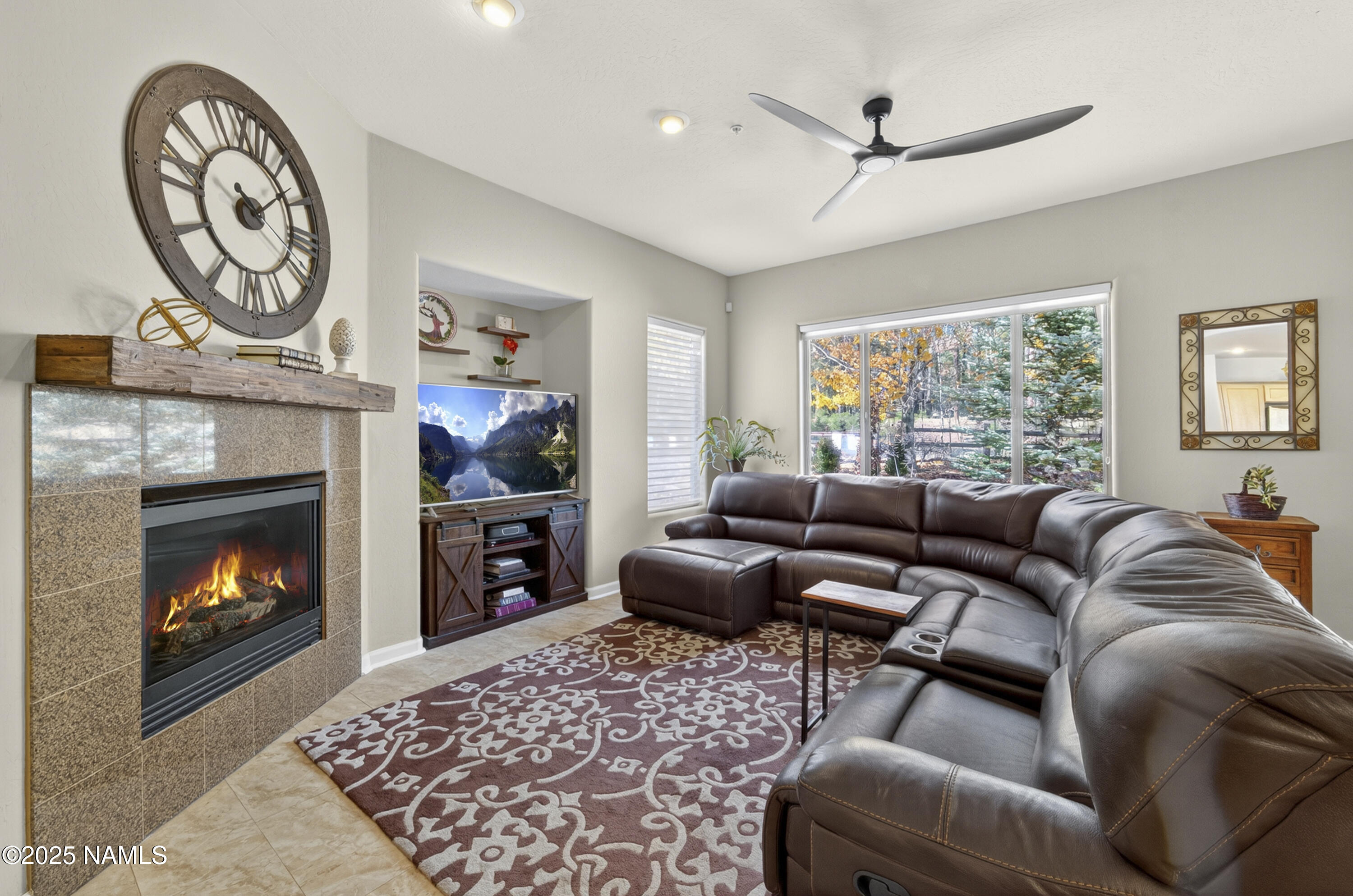 4900 West Quick Draw Flagstaff, AZ 86005 - Photo 5 of 36 a living room with furniture a window and a fireplace