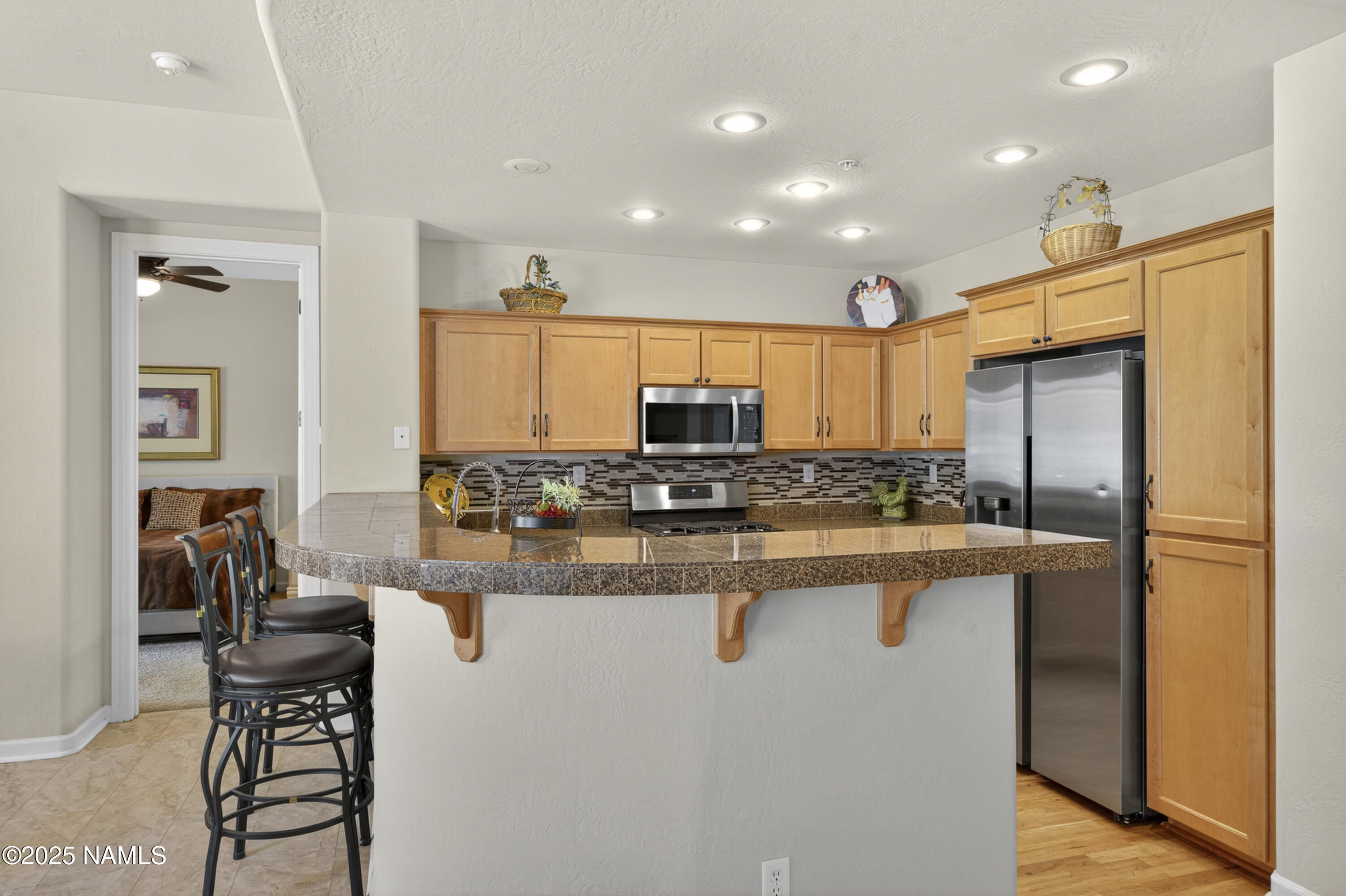 4900 West Quick Draw Flagstaff, AZ 86005 - Photo 36 of 36 a kitchen with stainless steel appliances granite countertop a refrigerator a stove and a sink with wooden floor
