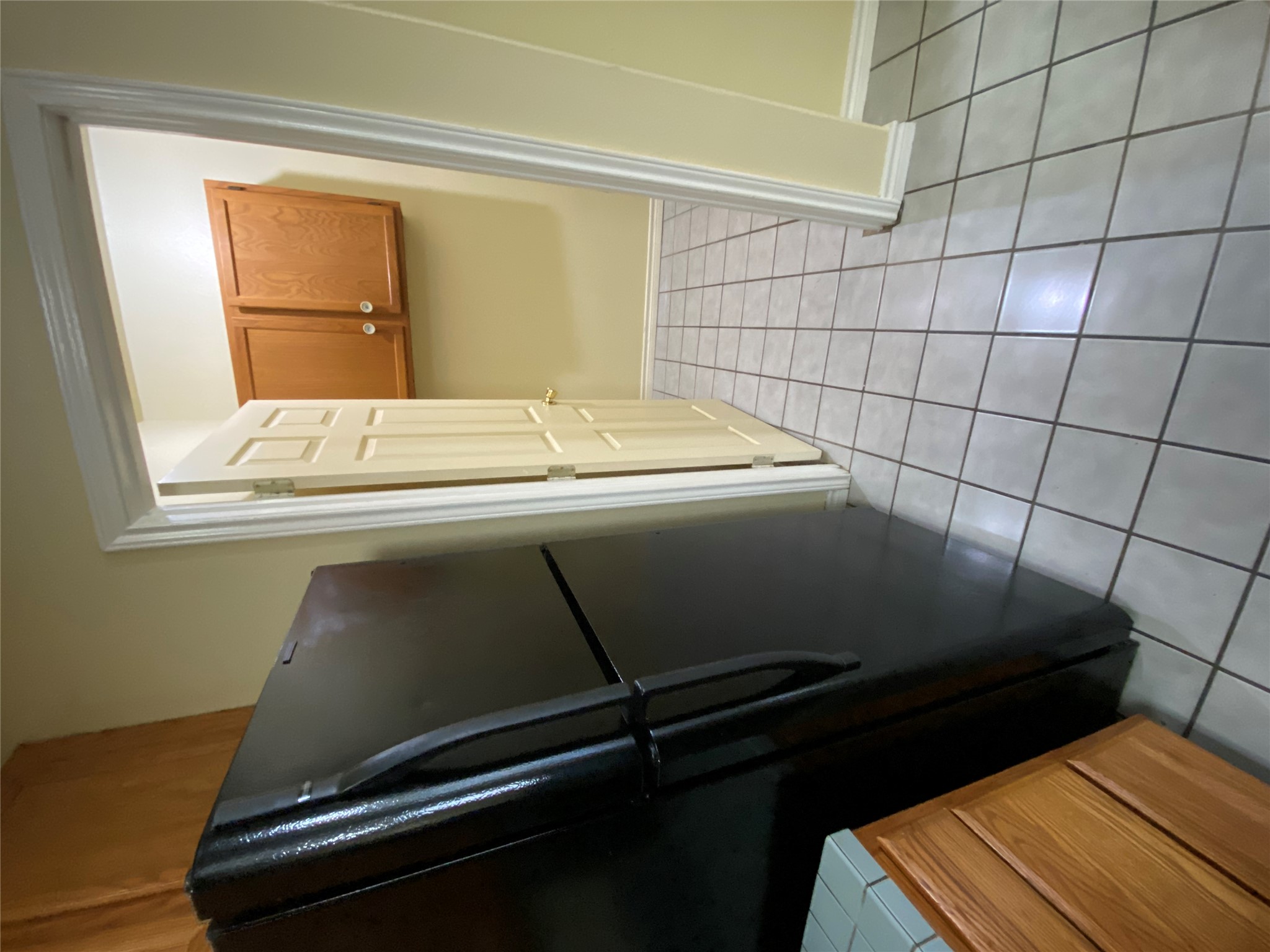 2605 Alcott Lane, Unit B Austin, TX 78748 - Photo 5 of 15 Functional kitchen offering a dark refrigerator and durable tile flooring leading to a pantry space.
