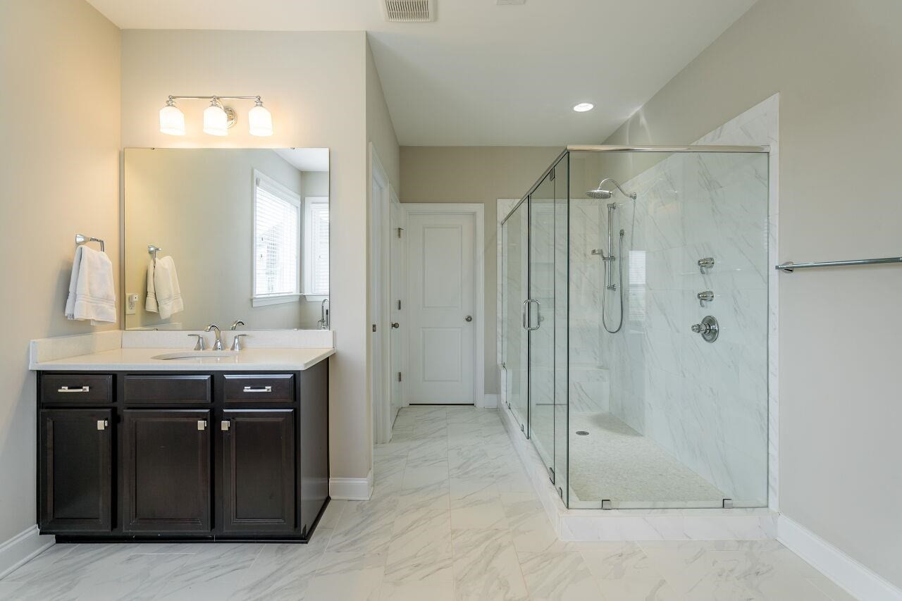 5264 Aleppo Lane Raleigh, NC 27613 - Photo 21 of 30 Sleek tile gives a glamorous look to this open bath. Owner's Bath