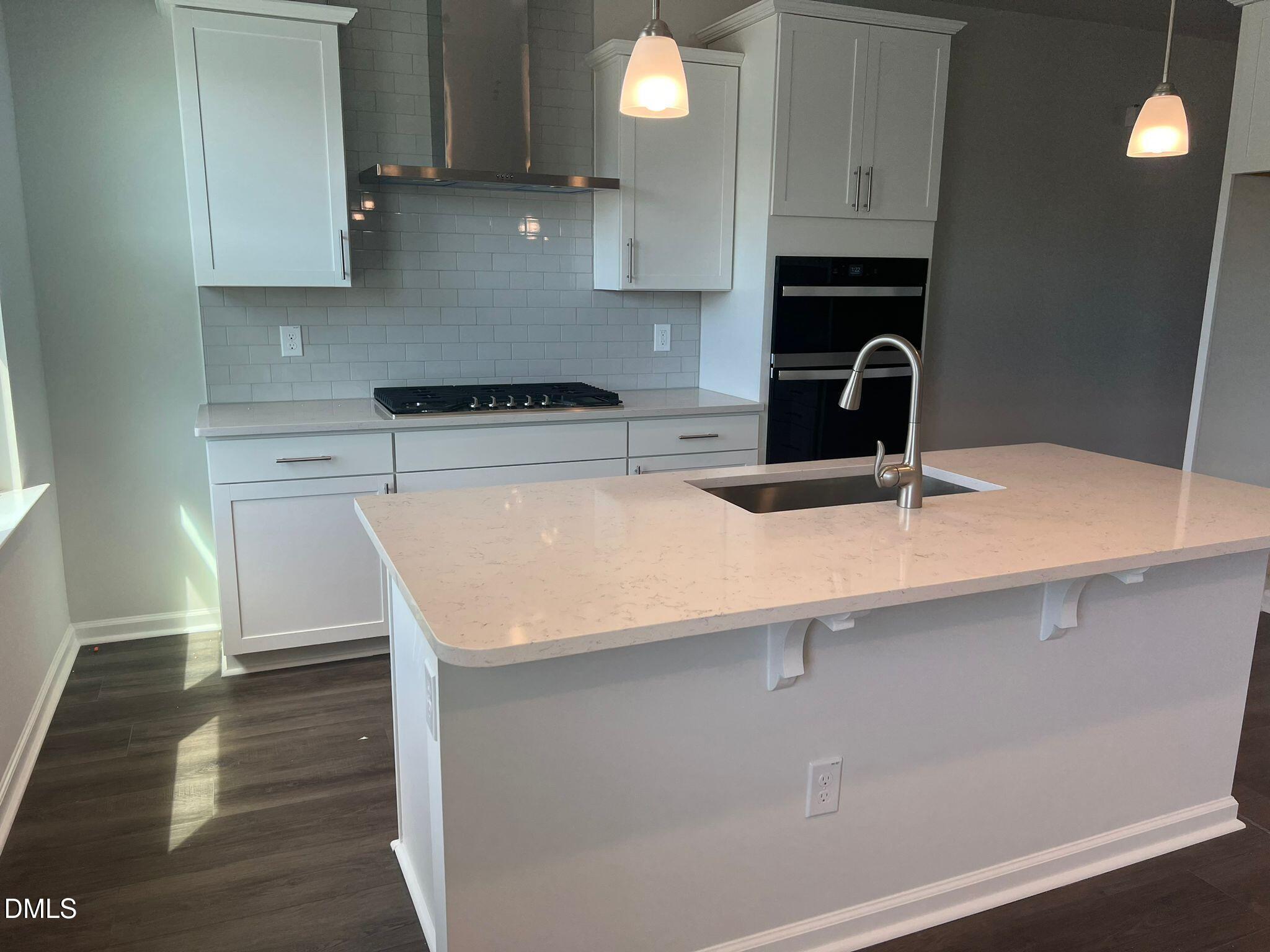 7226 Morris Acres Road Apex, NC 27523 - Photo 12 of 41 a kitchen with a sink a stove and cabinets