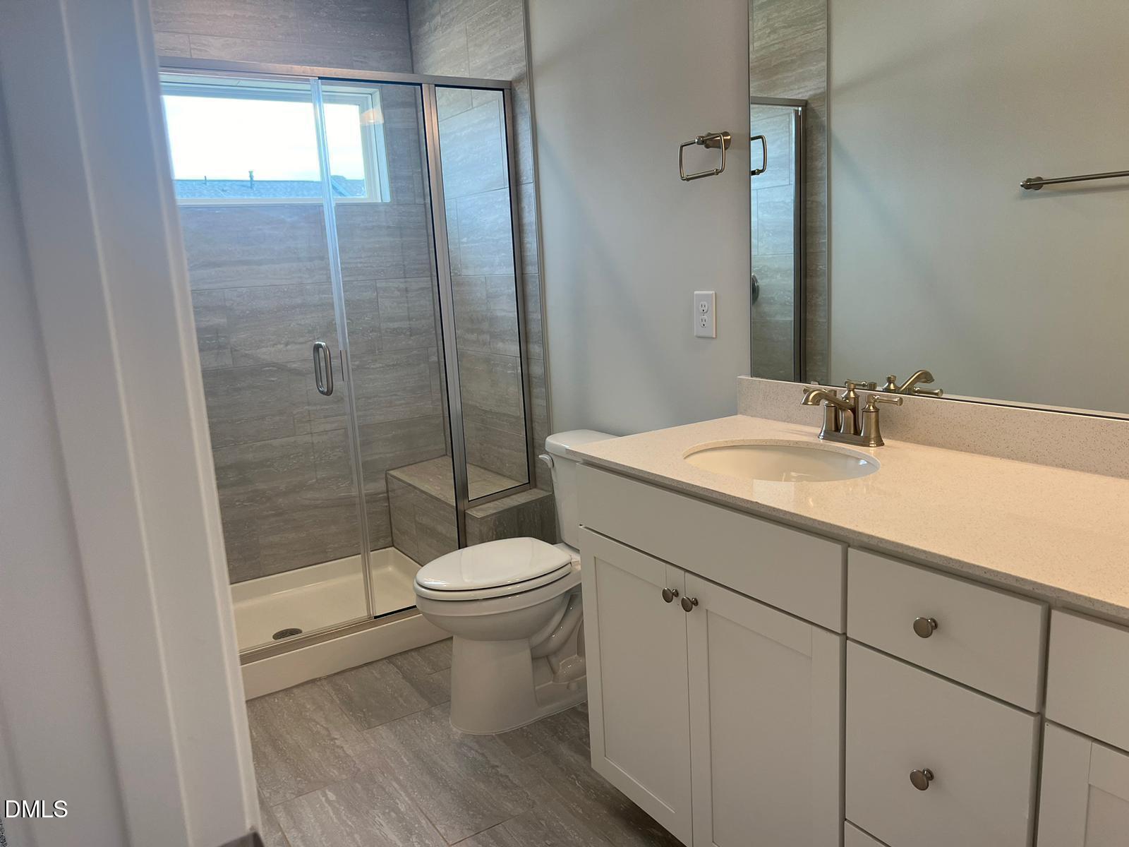 7226 Morris Acres Road Apex, NC 27523 - Photo 34 of 41 a bathroom with a sink a toilet and shower