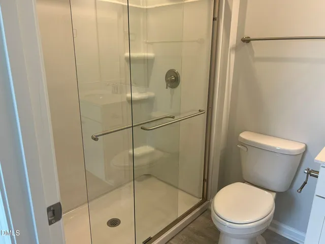 a bathroom with a shower and a toilet