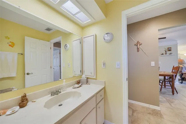 a view of a dining room with furniture and a chandelier fan