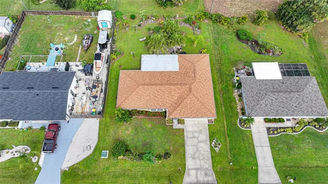 an aerial view of a houses with a yard