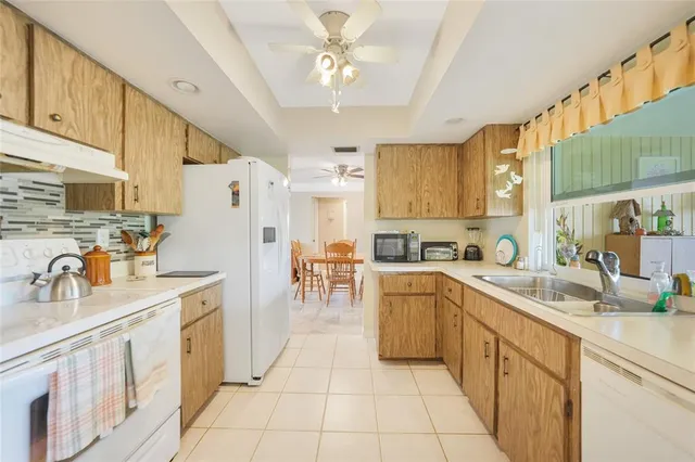 a kitchen with a sink window and cabinets