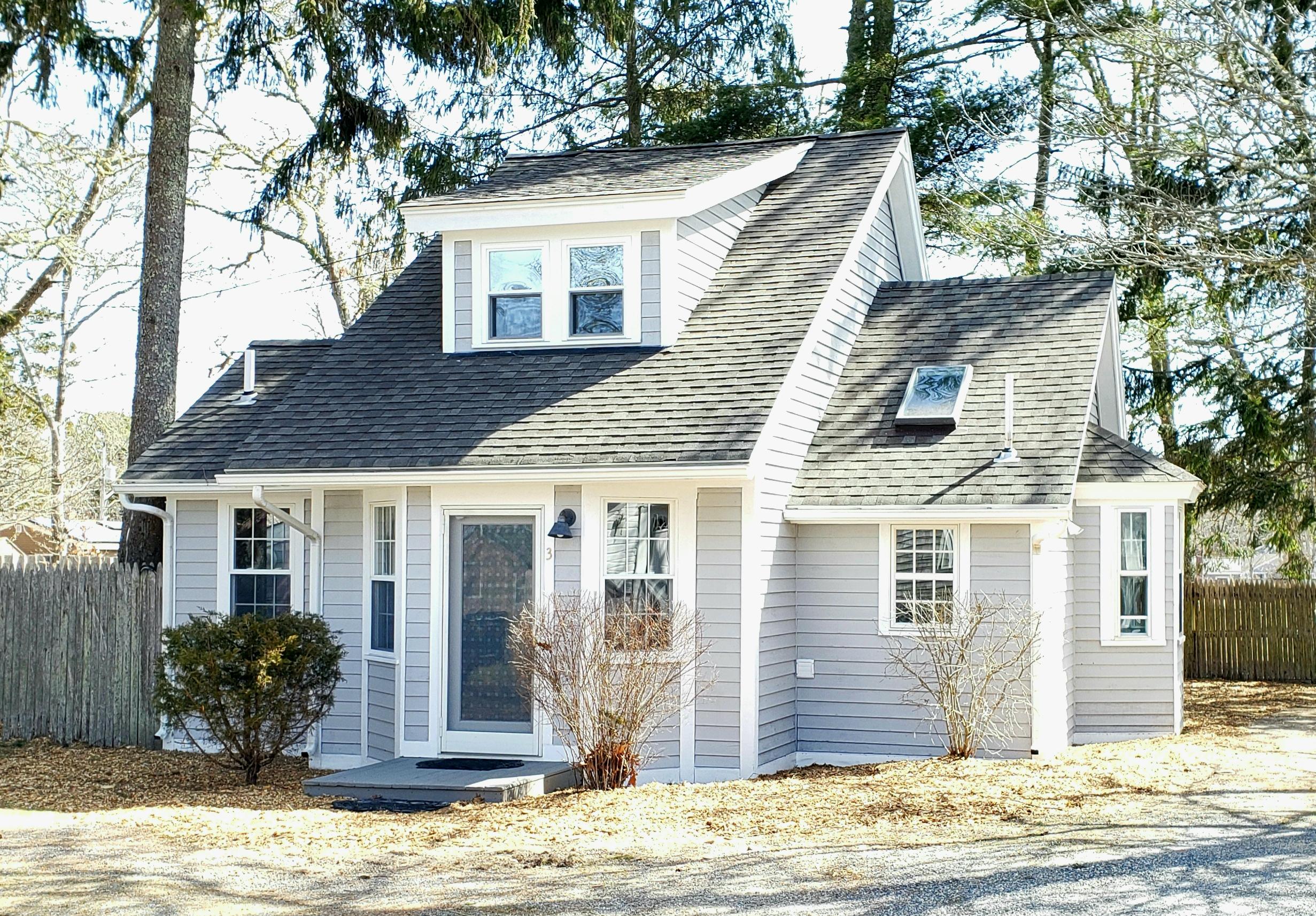 9 Bells Neck Road, Unit 3 West Harwich, MA 02671 - Photo 1 of 23 a view of a house with a tree in the background