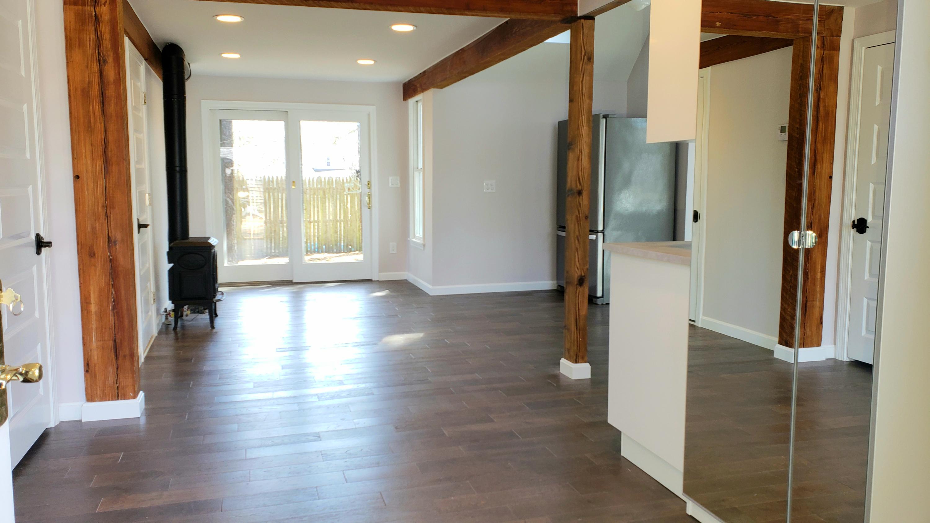 9 Bells Neck Road, Unit 3 West Harwich, MA 02671 - Photo 5 of 23 a view of a hallway with wooden floor and glass door